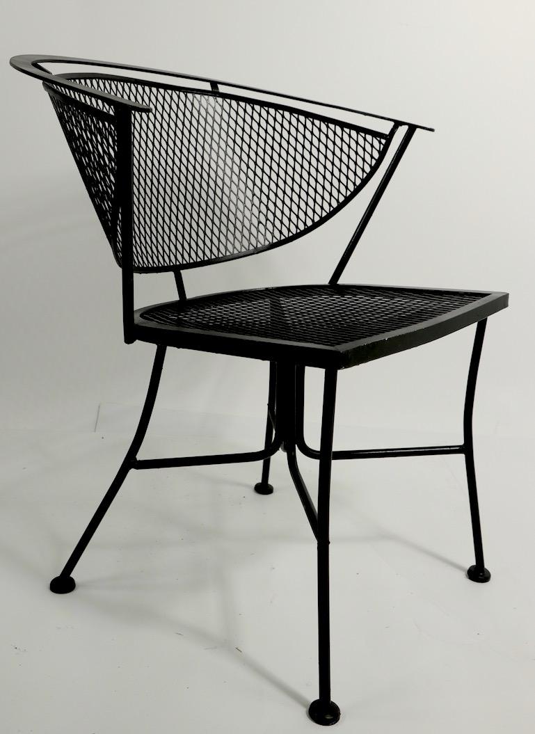 Nice set of four modernist chairs having wrought iron frames and mesh backrests and seats. Stylish architectural design, clean and ready to use condition. Currently in new black spray paint finish, suitable for indoor or outdoor use. 
 Total H 28.5