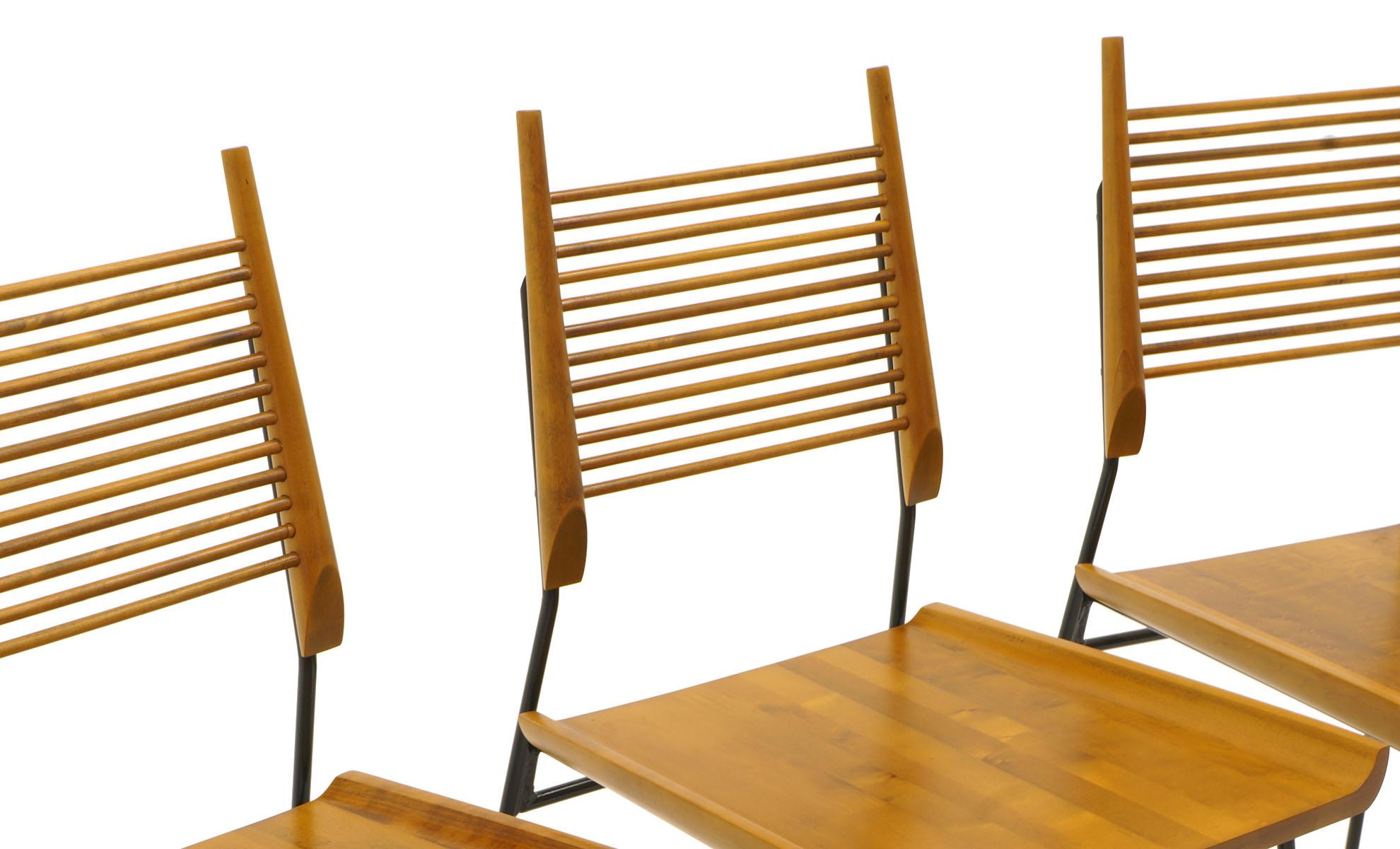 Expertly refinished set of four Paul McCobb Shovel chairs. Solid maple seats and backs with wrought iron frames. Look no further for a set of four in excellent condition.