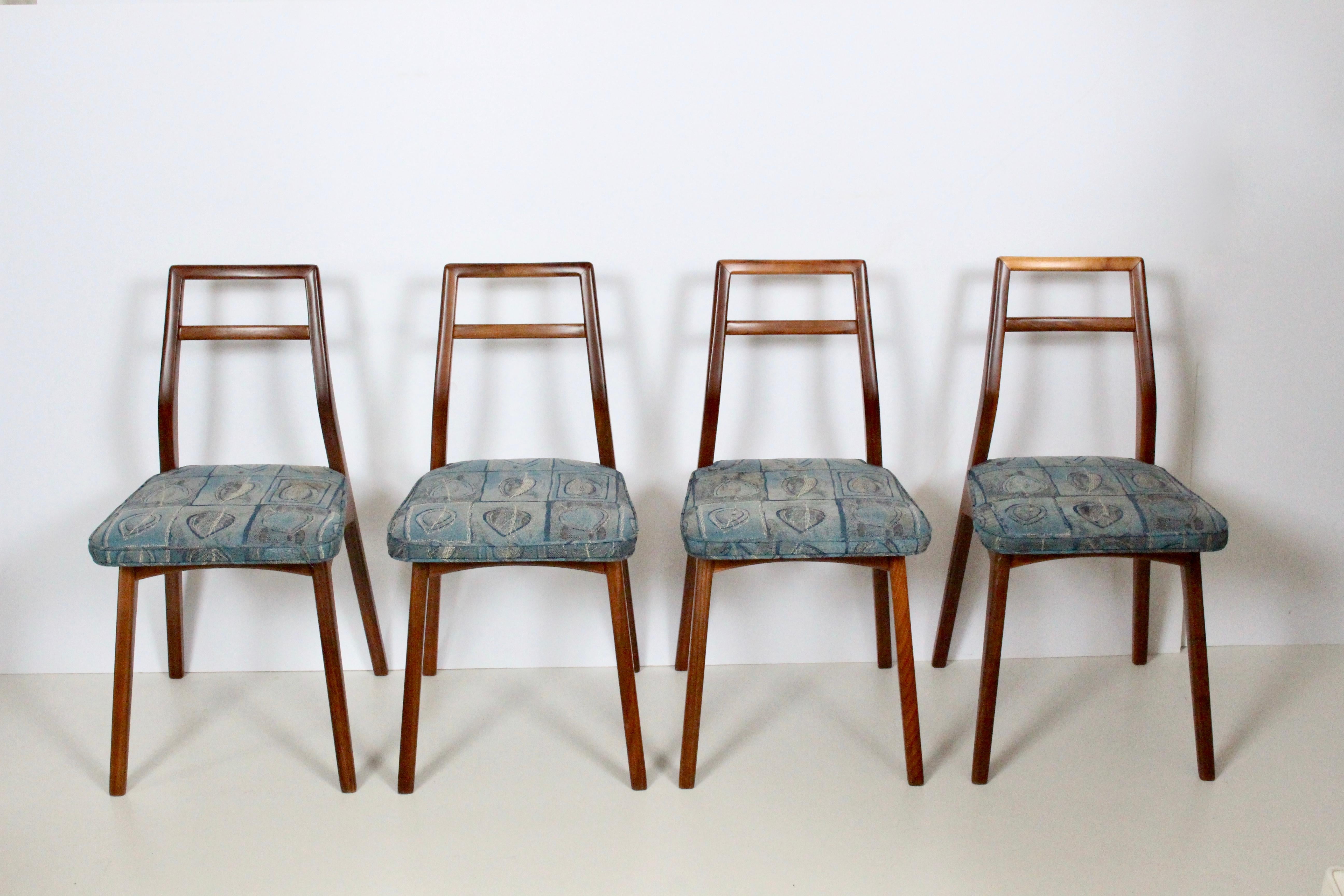 Set of four Paul McCobb for O'Hearn style black walnut side chairs, 1950's. Featuring a refinished, sturdy and angled solid Walnut framework with newly upholstered seats  in varied shades of Blue with leaf patterns. Timeless. Classic. Comfort.

 