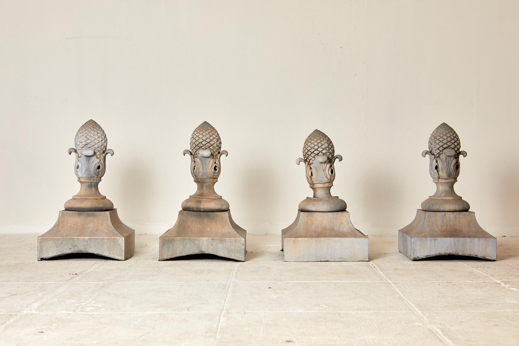 Building and Garden Elements,
Set of four pine cone-shaped finials, 
zinc, 
circa 1990, France.
Height 53 cm, width 32 cm, depth 32 cm.