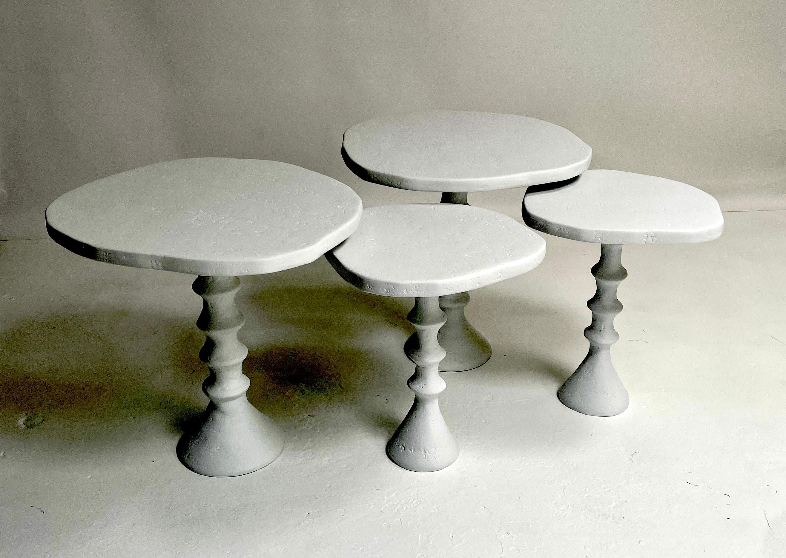 This grouping of four of our St Paul Plaster tables create a versatile table option. The four tables can be arranged to work as a coffee table, or side tables. They nest together or stand alone. The set is made up of two Moyen Modèle tables. 
(