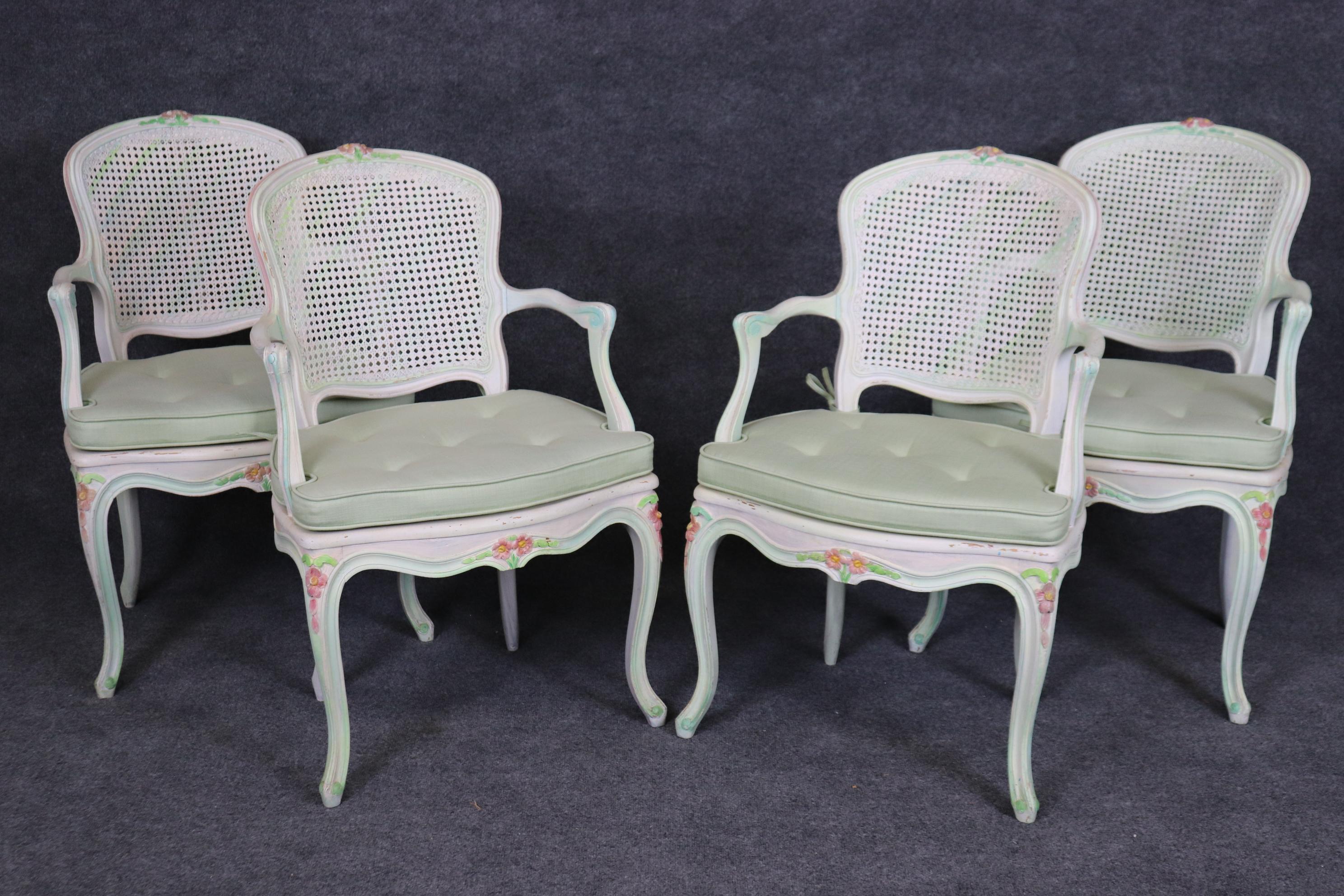 These are gorgeous painted and polycromed set of 4 armchairs. Measures 33.75 tall x 22 wide x 23 deep and seat height 19 inches seat height. The chairs date to the 1940s era. 