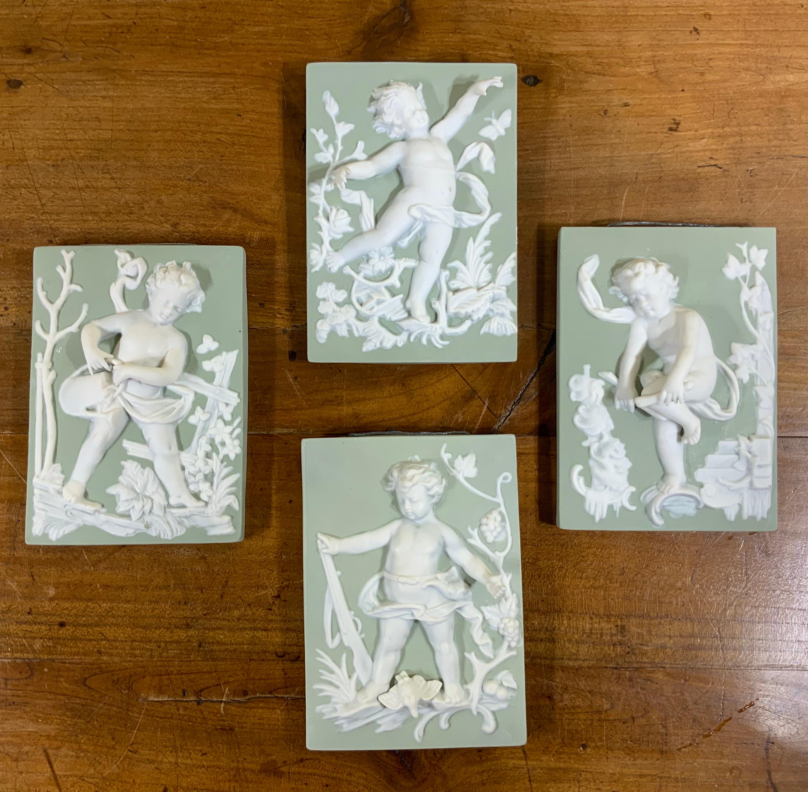 Celadon Set of Four Porcelain-Bisque Cherubs Statues