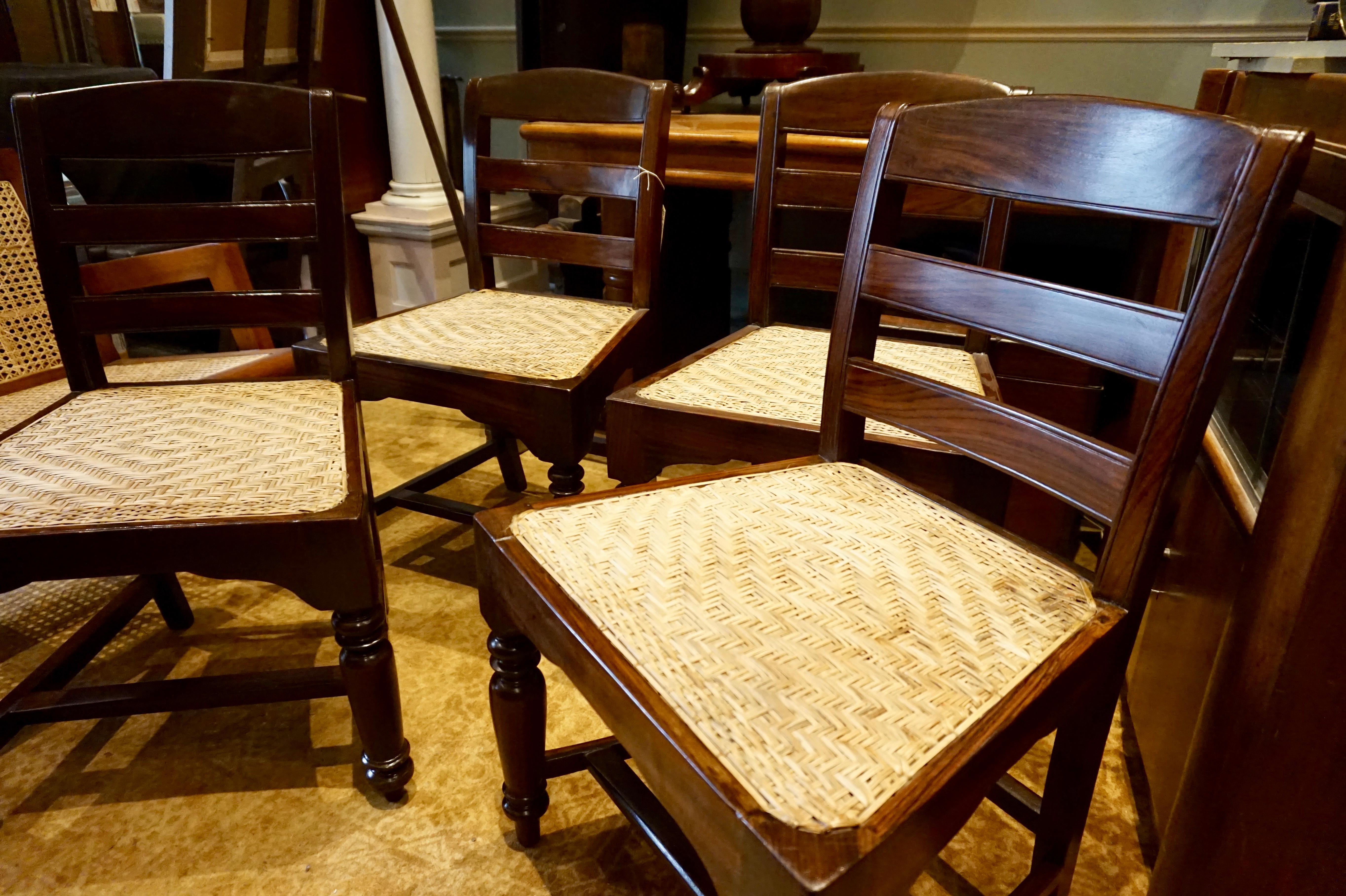 Set of four Portuguese rosewood chairs with woven rattan cane seats.
Hand carved solid rosewood chairs with basket weave re-caned seats. United by stretcher at base. Chairs are in good sturdy condition,
circa 1890s.