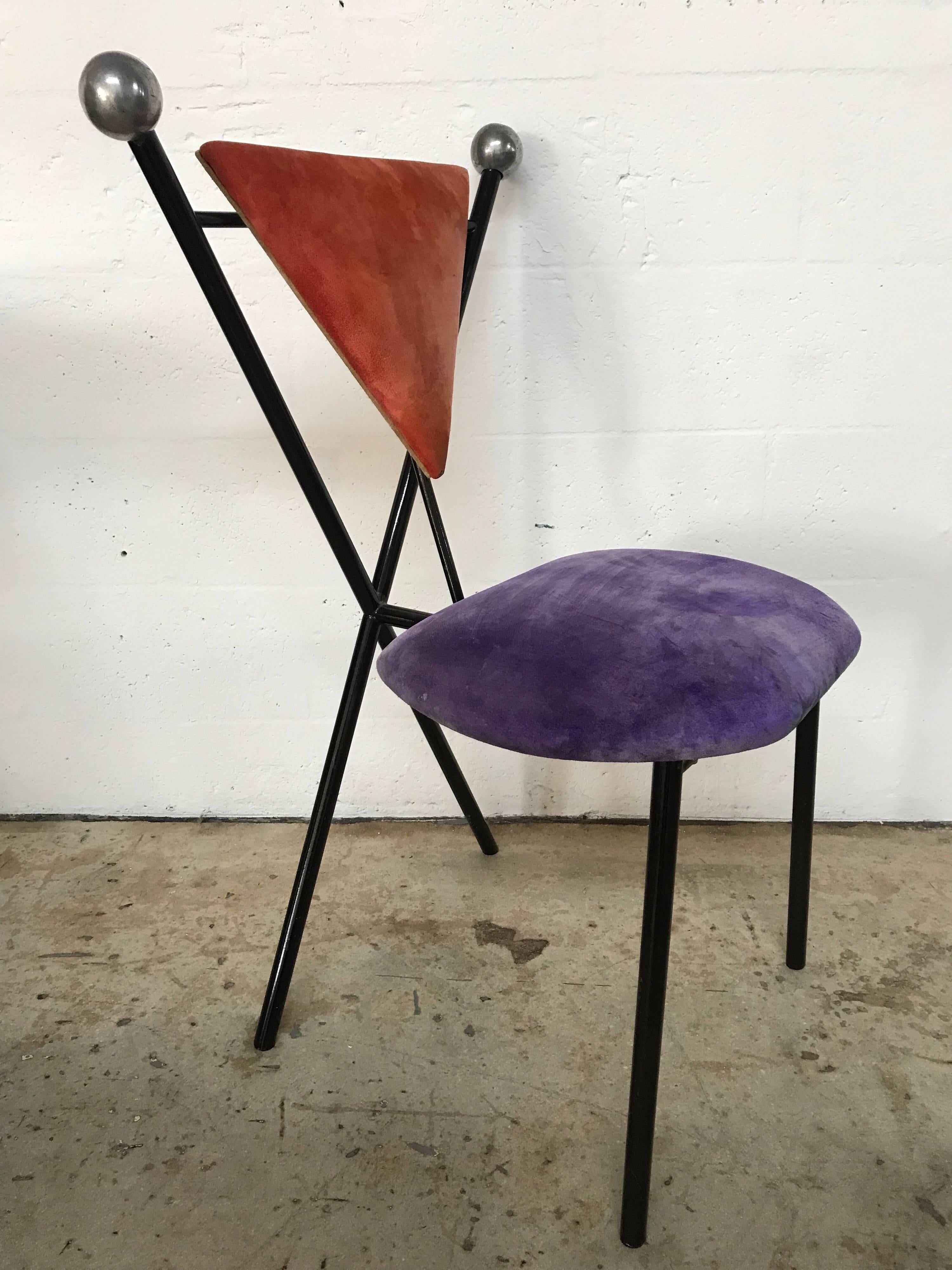 Unique set of Postmodern dining chairs, each of the four chairs in this set are upholstered in a different color of coordinating velvet with black powder coated frames and polished steel finials.

Reupholstery recommended.