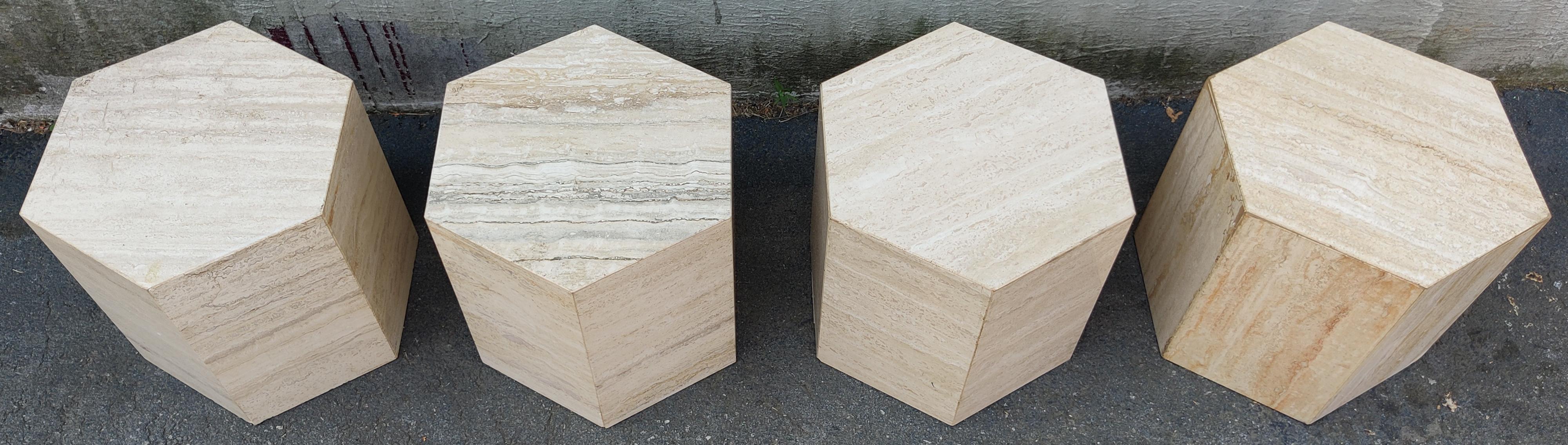 A set of four Italian travertine marble haxagonal side tables or pedestals. The polished travertine is beige and cream colored with beautiful variation. Notice in some areas the grain develops a red or rust-colored hue, which adds to its beauty and