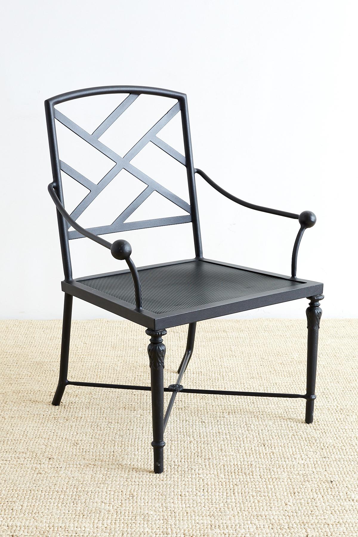 Neoclassical styled set of four aluminum garden or patio chairs featuring a thick black powder coated finish and mesh seats. The chairs have an Asian themed open fretwork design back and neoclassical style column front legs and stretchers. The