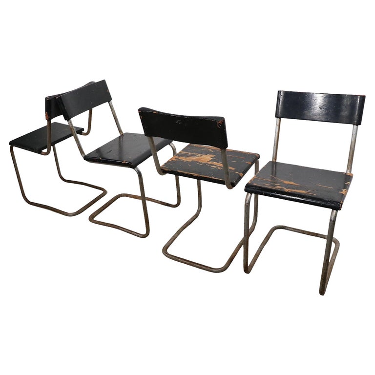 Early version of the Breuer classic cantilevered dining chair. These chairs feature solid wood seats, and backrests, on tubular chrome frames. We believe these date from the 1920's - 1930's, and were made in the USA, they are unmarked. All are