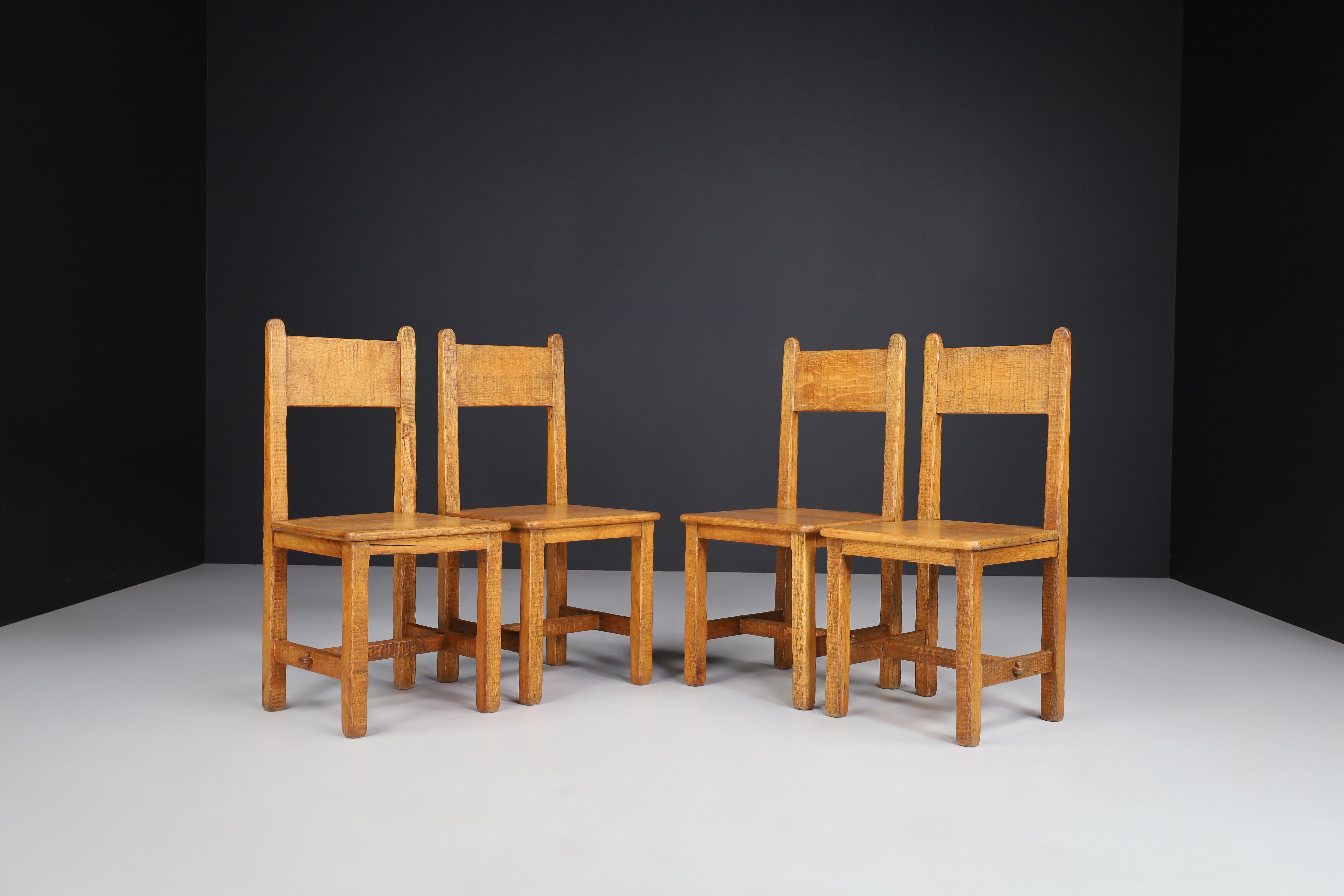 Set of four primitive chairs in patinated oak, France 1950s.

Set of four primitive chairs in solid oak France 1950s. These chairs are in original and untouched condition, with amazing original patina. These particular chairs are as solid and