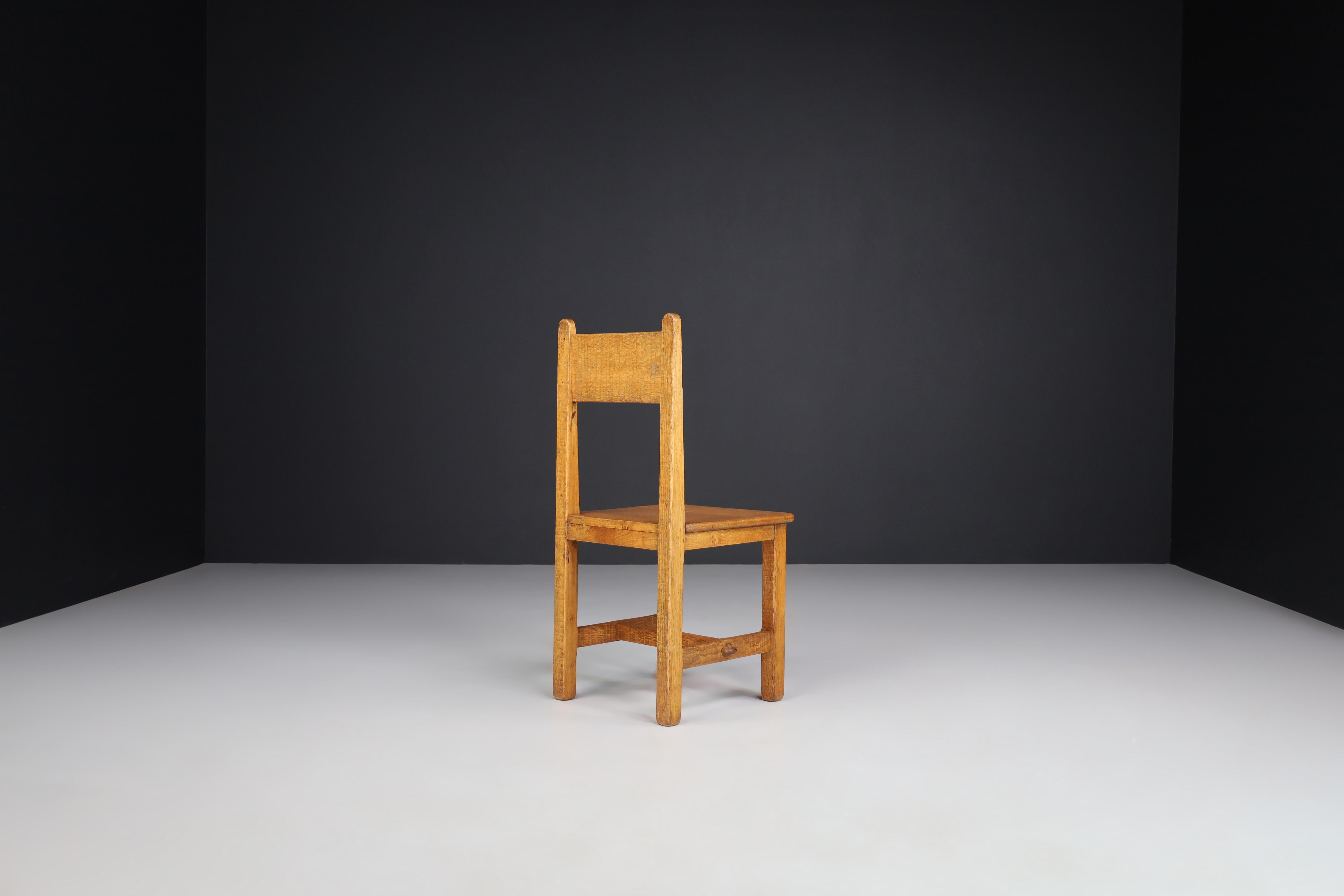 20th Century Set of Four Primitive Chairs in Patinated Oak, France, 1950s For Sale