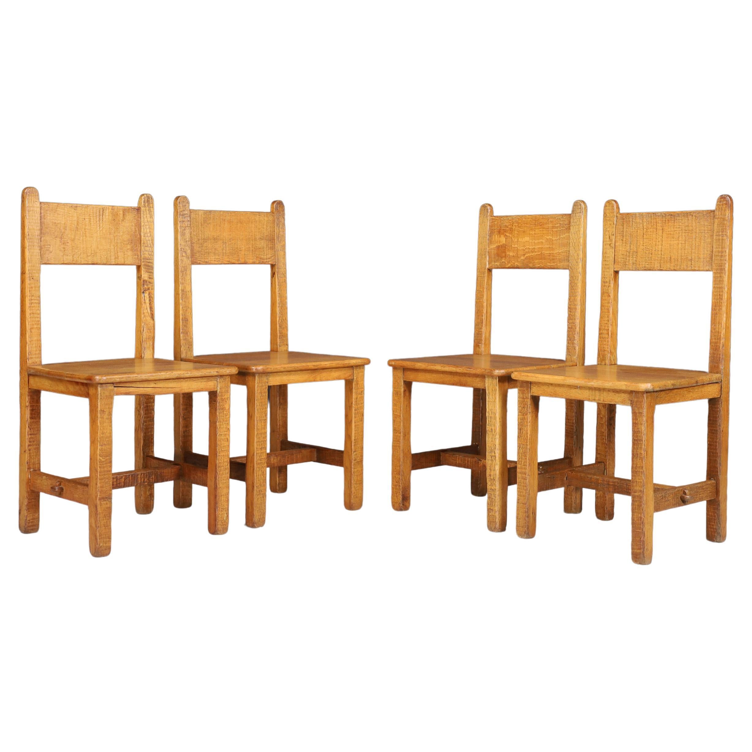 Set of Four Primitive Chairs in Patinated Oak, France, 1950s