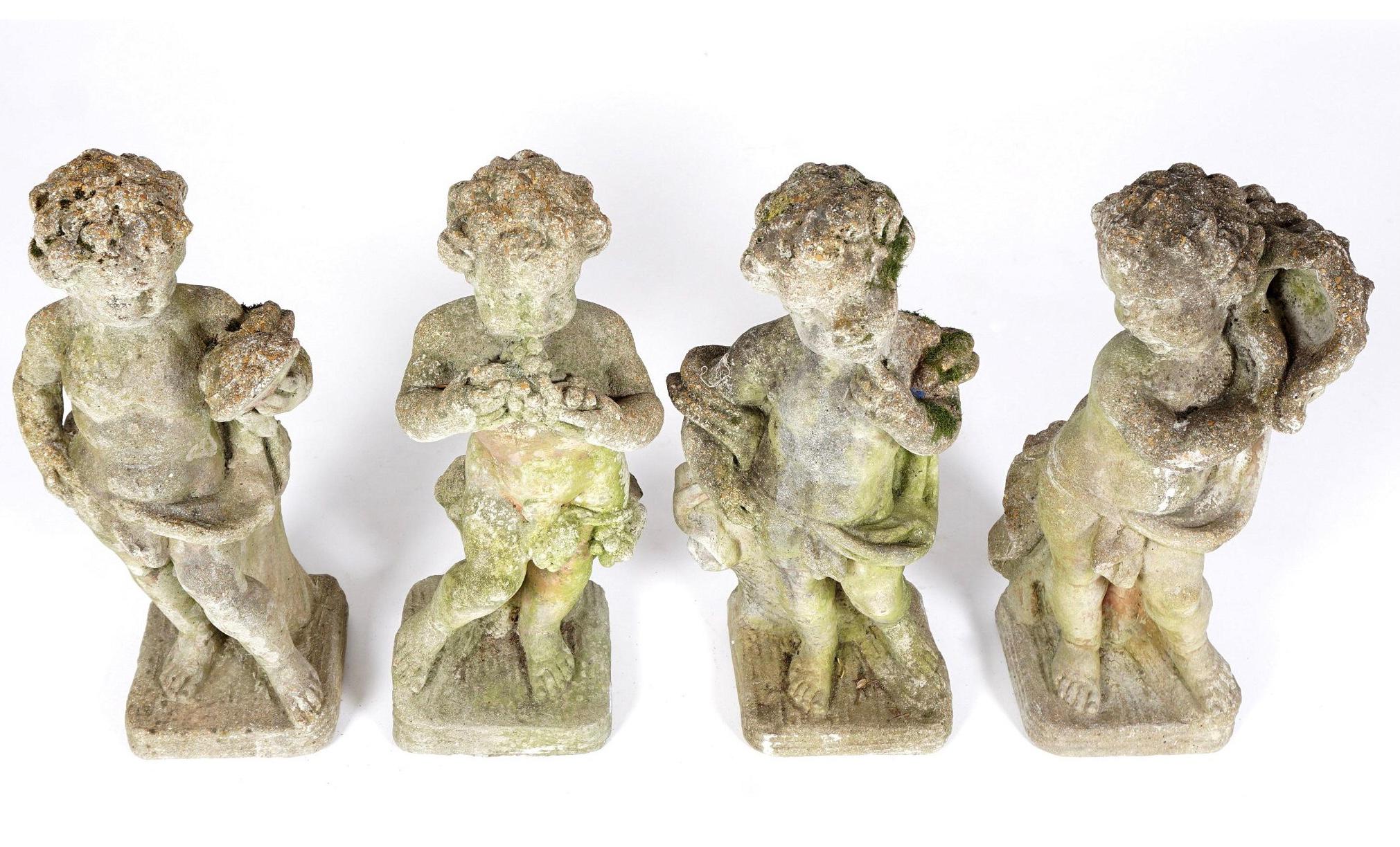 A charming set of 4 life-size garden statues in cast stone, early 20th century, depicting putti in various poses, possibly the four seasons. Nice patina with traces of lichen and moss.