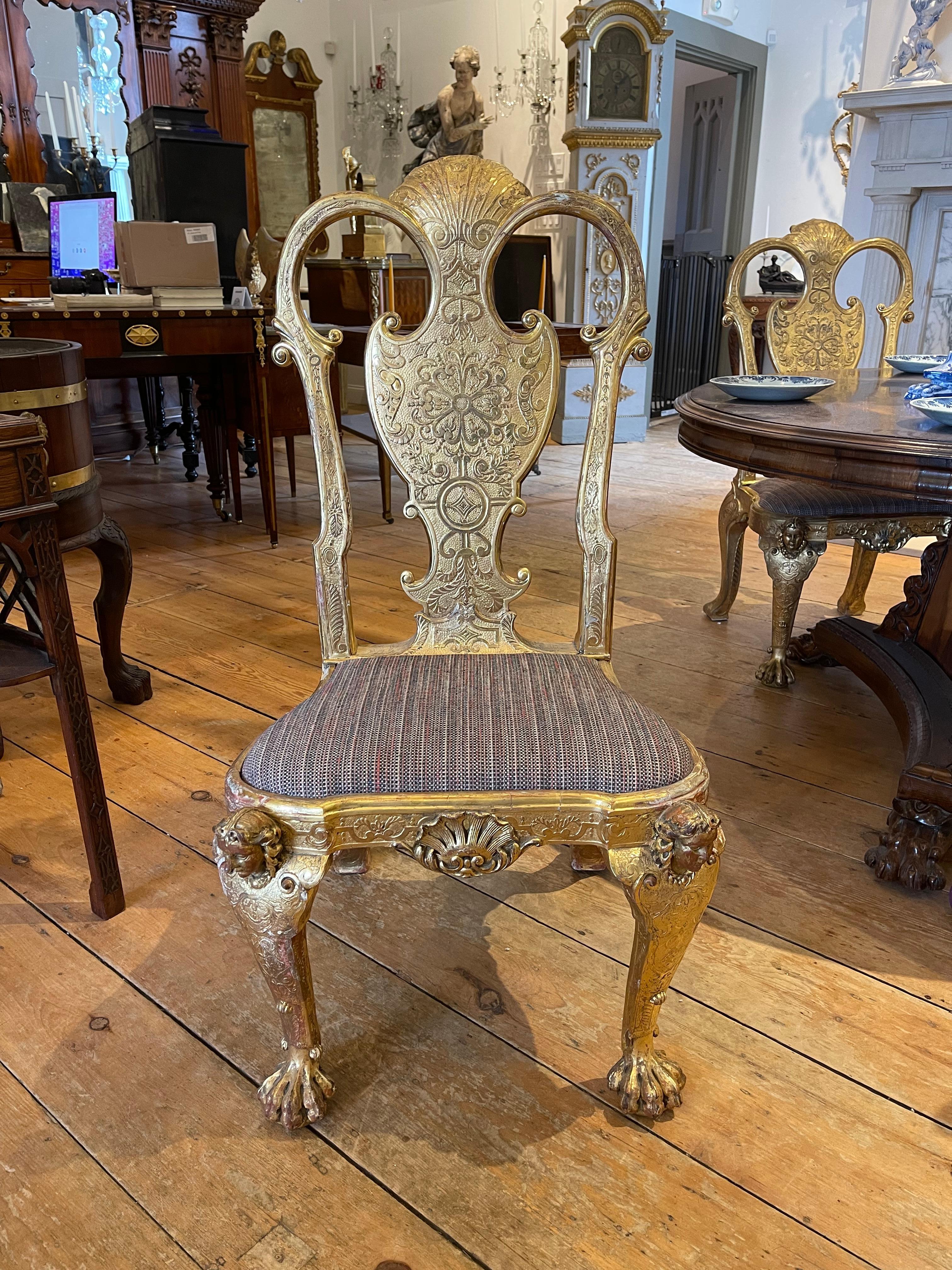 Remarkable Set of Four Queen Anne or George I Style Gilded Side Chairs.  Carved and gilt gesso in original water gilding.  Large, 18th Century Size and proportion.  Magnificent form.  Usable and impressive.

Wear to gilding, some chipping but
