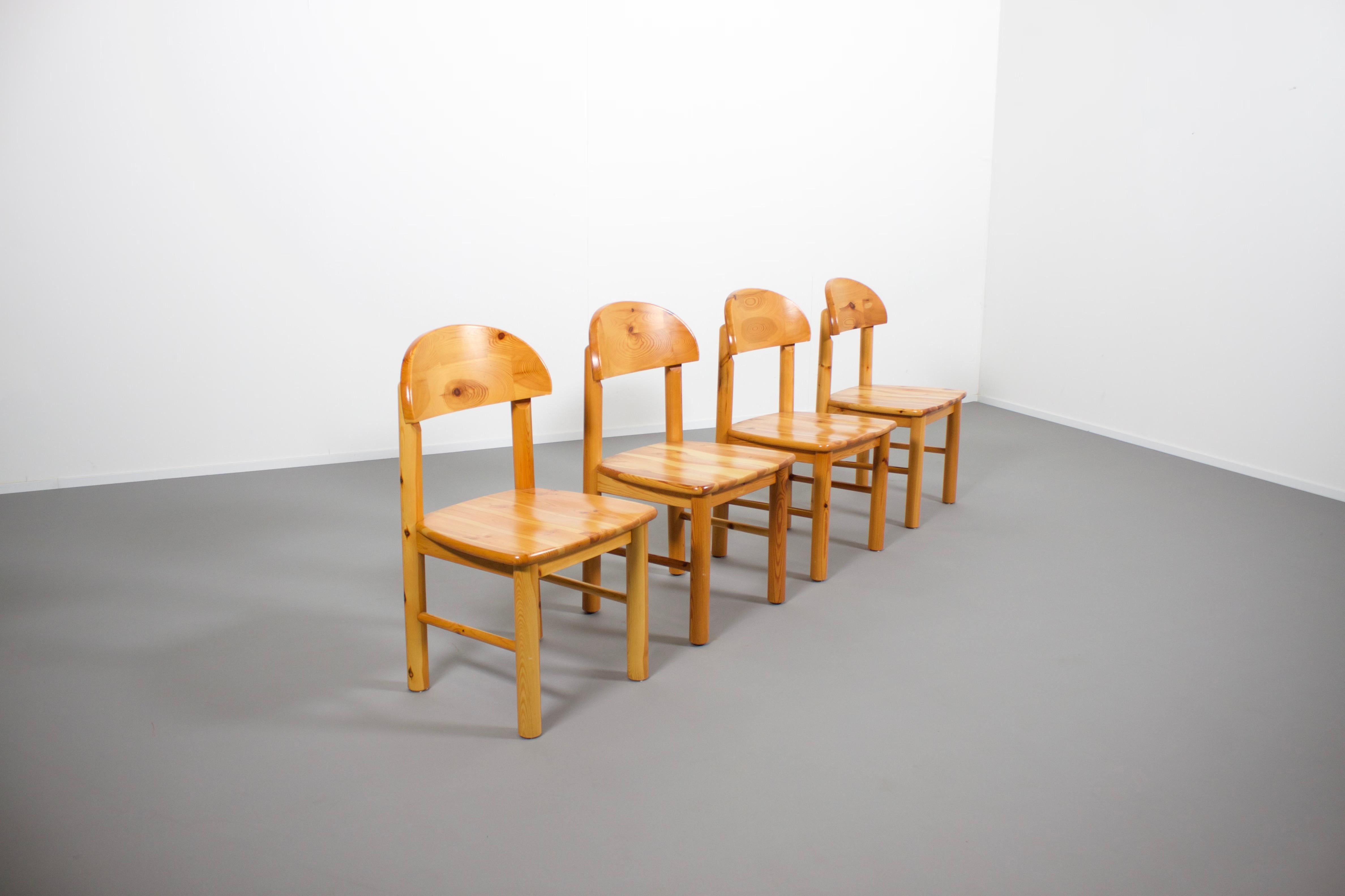 Set of four solid pine wood chairs in very good condition.

Designed by Rainer Daumiller and manufactured by Hirtshals Savvaerk in the 1970s 

The chairs have a carved seat and backrest which give them a robust and organic appearance.

The rustic