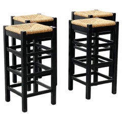 set of four rattan and wood barstools