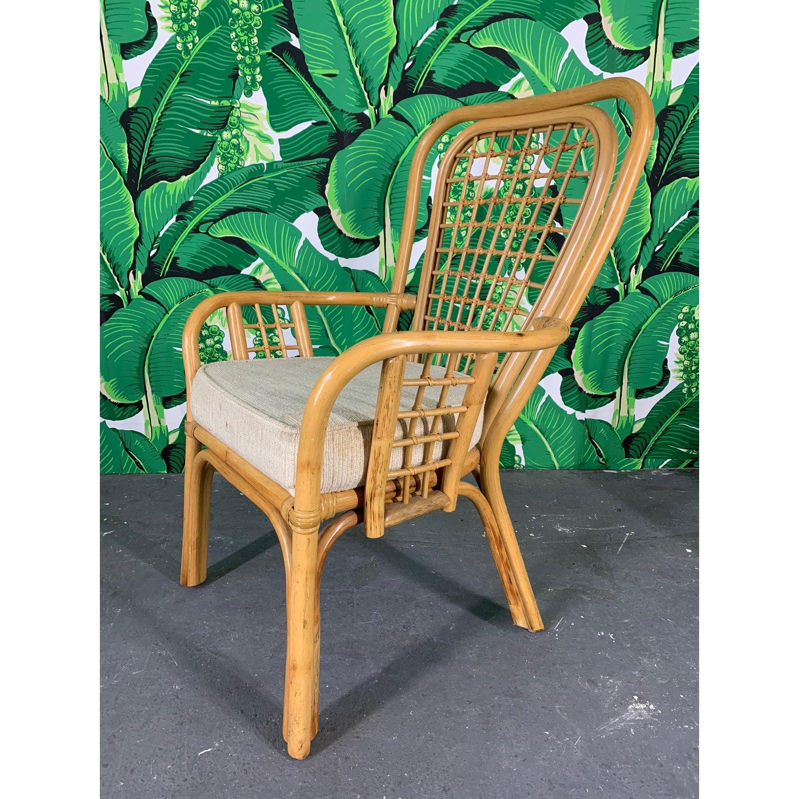 Set of 4 rattan dining chairs feature a fan back design and thick, upholstered seats. Very good vintage condition with only minor signs of age appropriate wear.