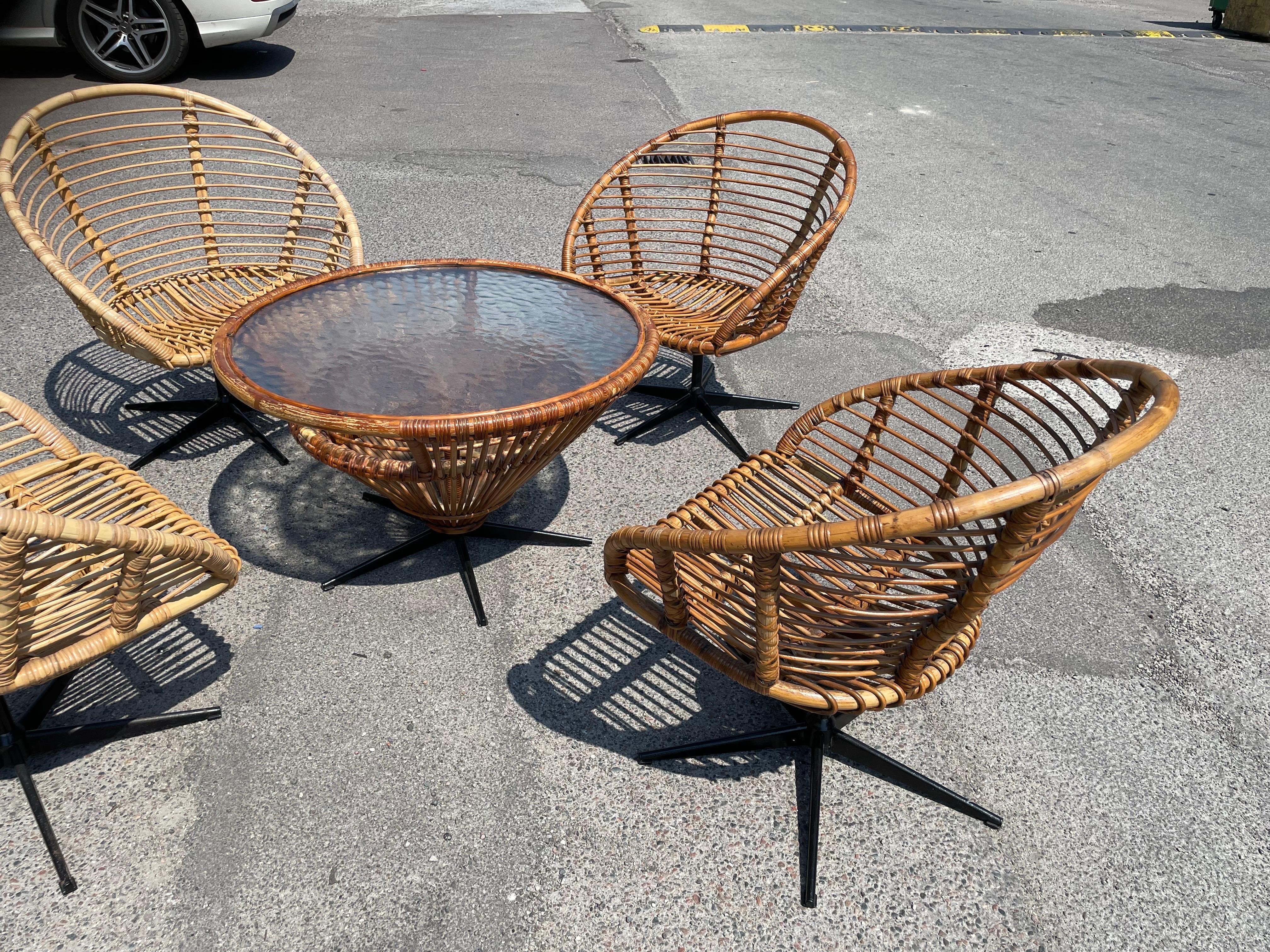 Mid-20th Century Set of four rattan swivel chairs with a matching table from the 1960´s For Sale