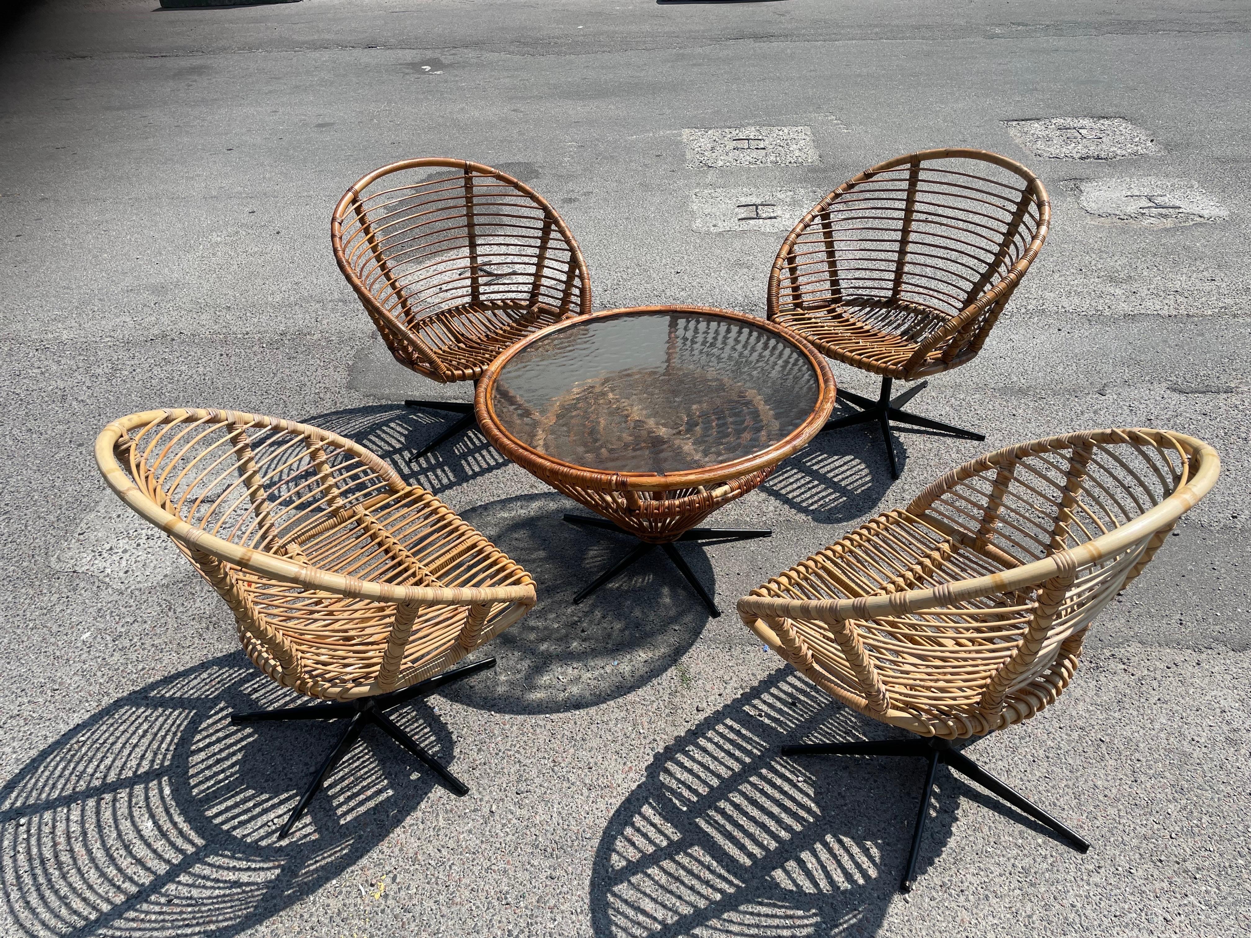 Rattan Set of four rattan swivel chairs with a matching table from the 1960´s For Sale