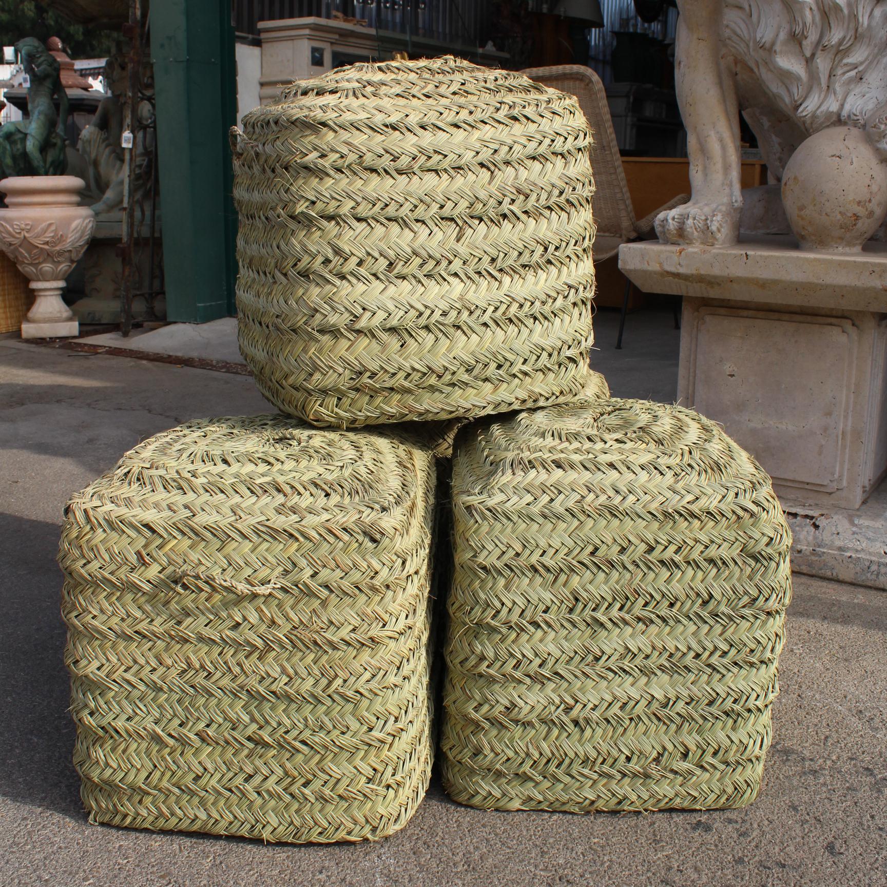 Set of four rattan hand-sewn puffs.