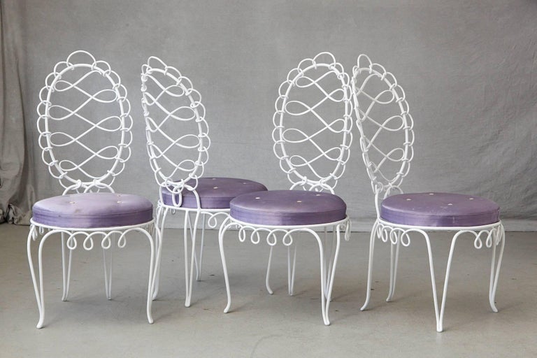 A gorgeous set of four 'fer forgé rond' - iron side chairs designed by René Prou (French 1889-1947), France, circa 1940s.
The chairs are decorated with a delicate scrolled design, the apron with conforming pendant loops as in the oval back, pierced