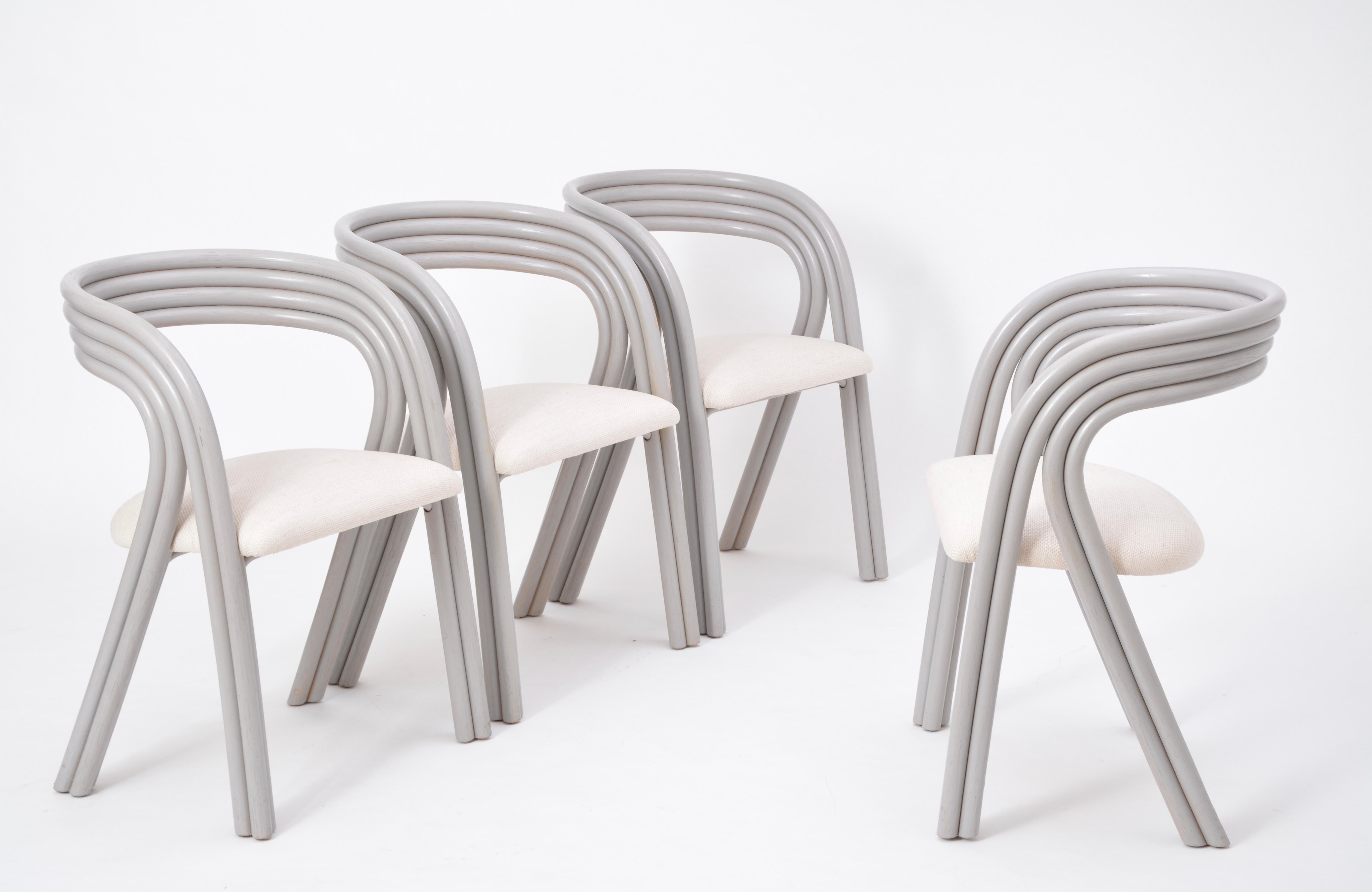 Very elegant set of four reupholstered dining chairs designed by the famous Belgian designer Axel Enthoven for Rohé Noordwolde. The sculptured frames are made of grey colored bended rattan. The set is in an excellent vintage condition. Untypical for