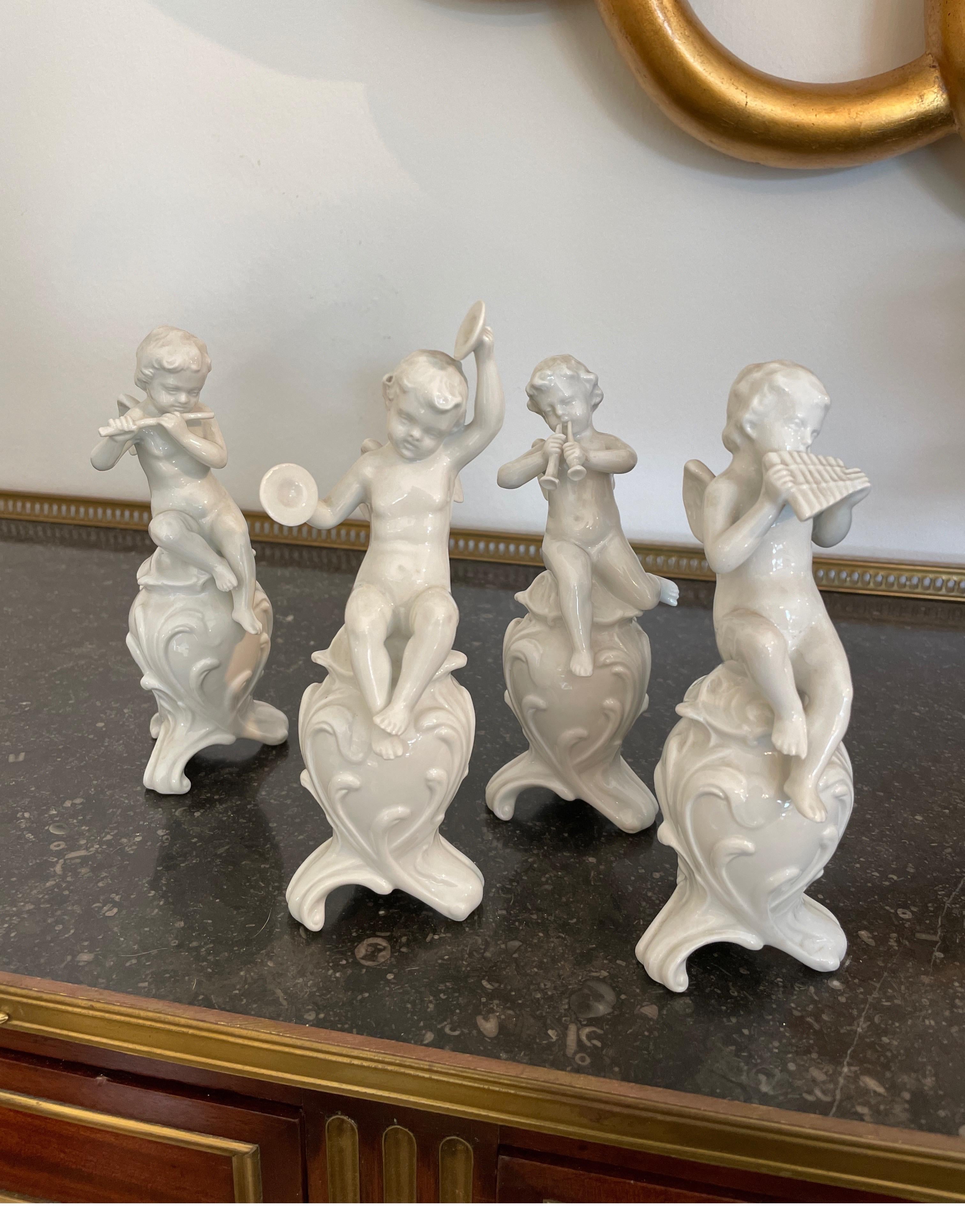 Set of four Ginori white porcelain musical cherubs.