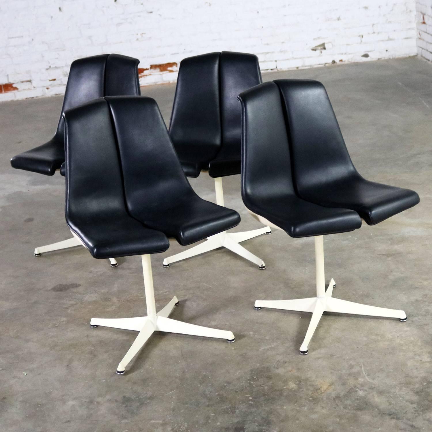 Incredible set of four I48 stacking chairs by Richard Schultz for Knoll. This set is in wonderful vintage condition. The black faux leather or Naugahyde is in fabulous shape; however, the white finish on the shells, shaft, and feet has some
