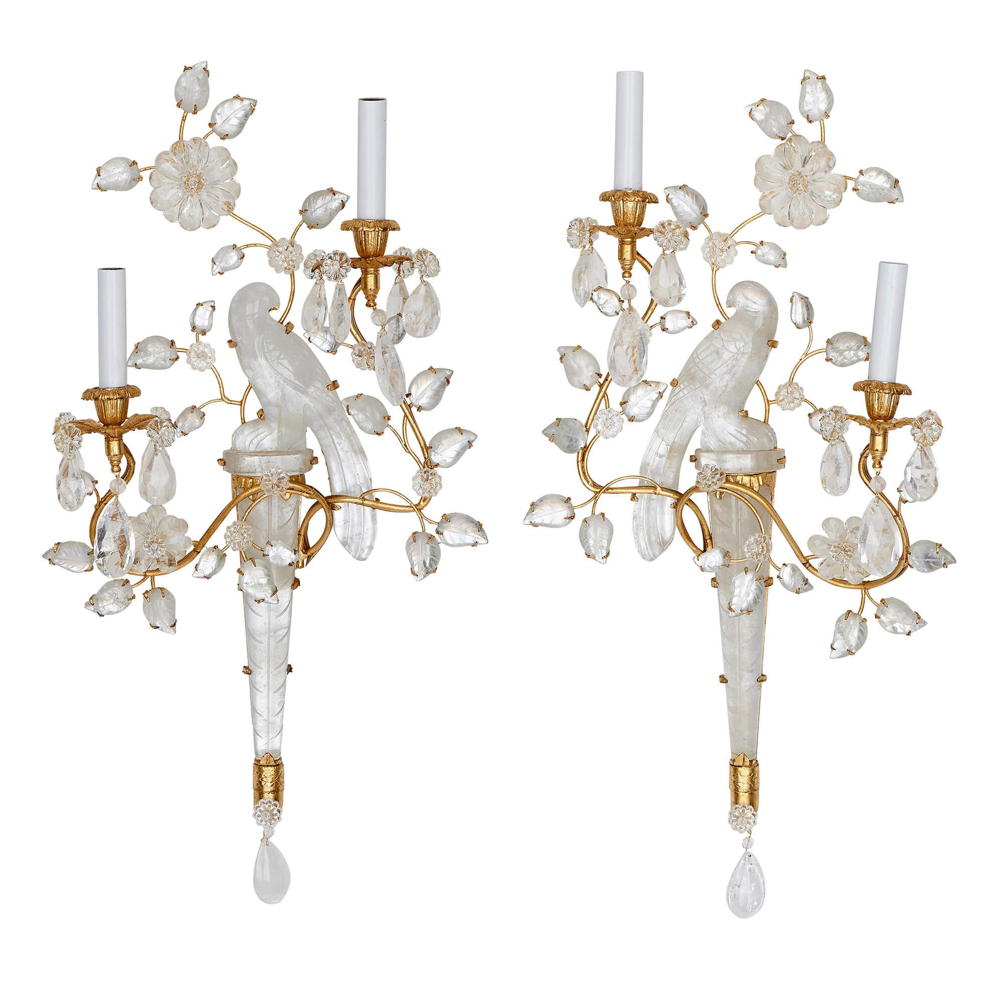 This set of four wall sconces have been crafted in the fashionable Maison Bagues style. They are distinctive for their elegant bird and flower forms that have been crafted from molded glass and rock crystal. 

Founded by Noel Bagues in 1860, the