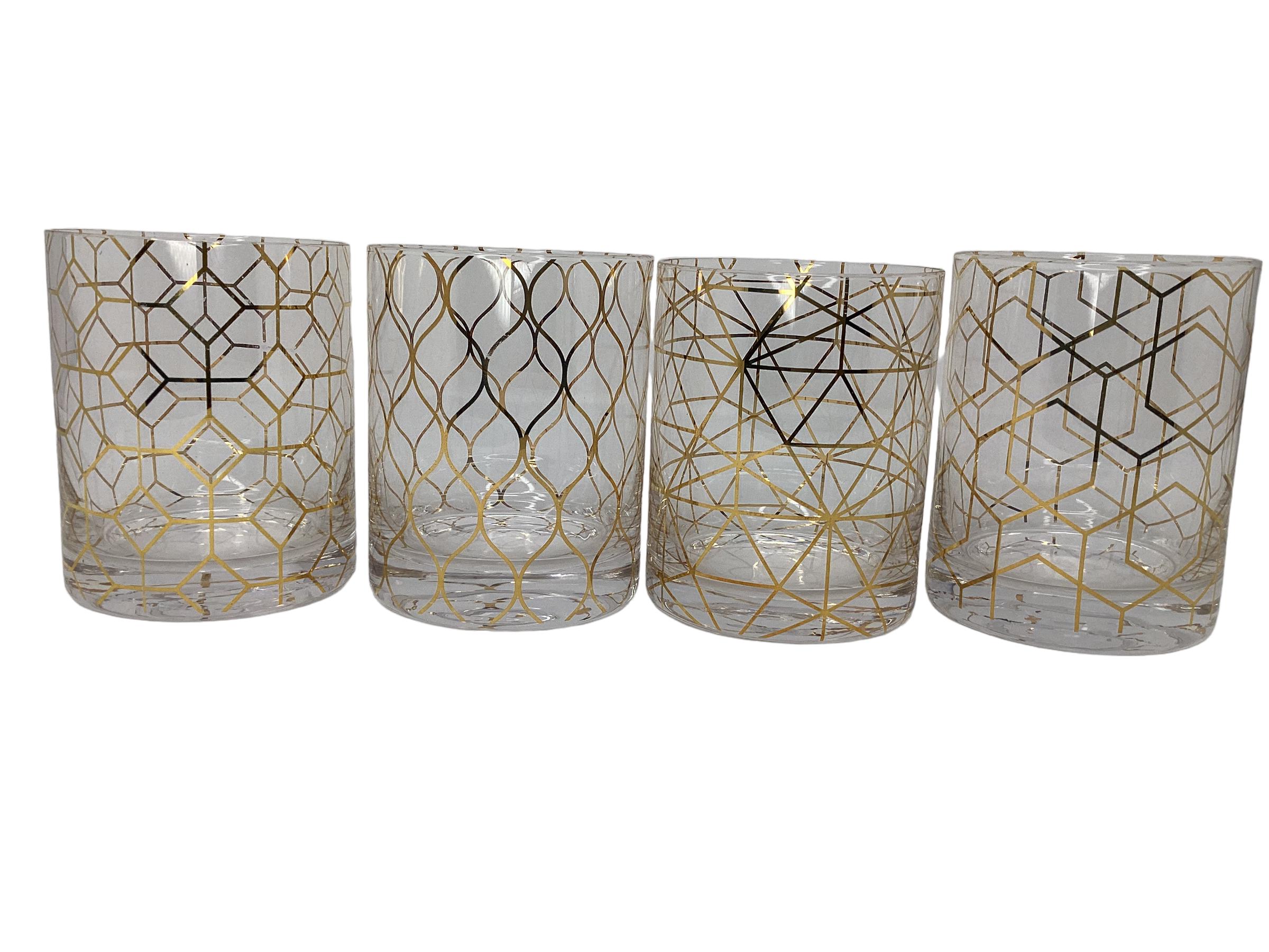 Set of four gold decorated rocks glasses, each with a different geometric design. All in excellent vintage condition.