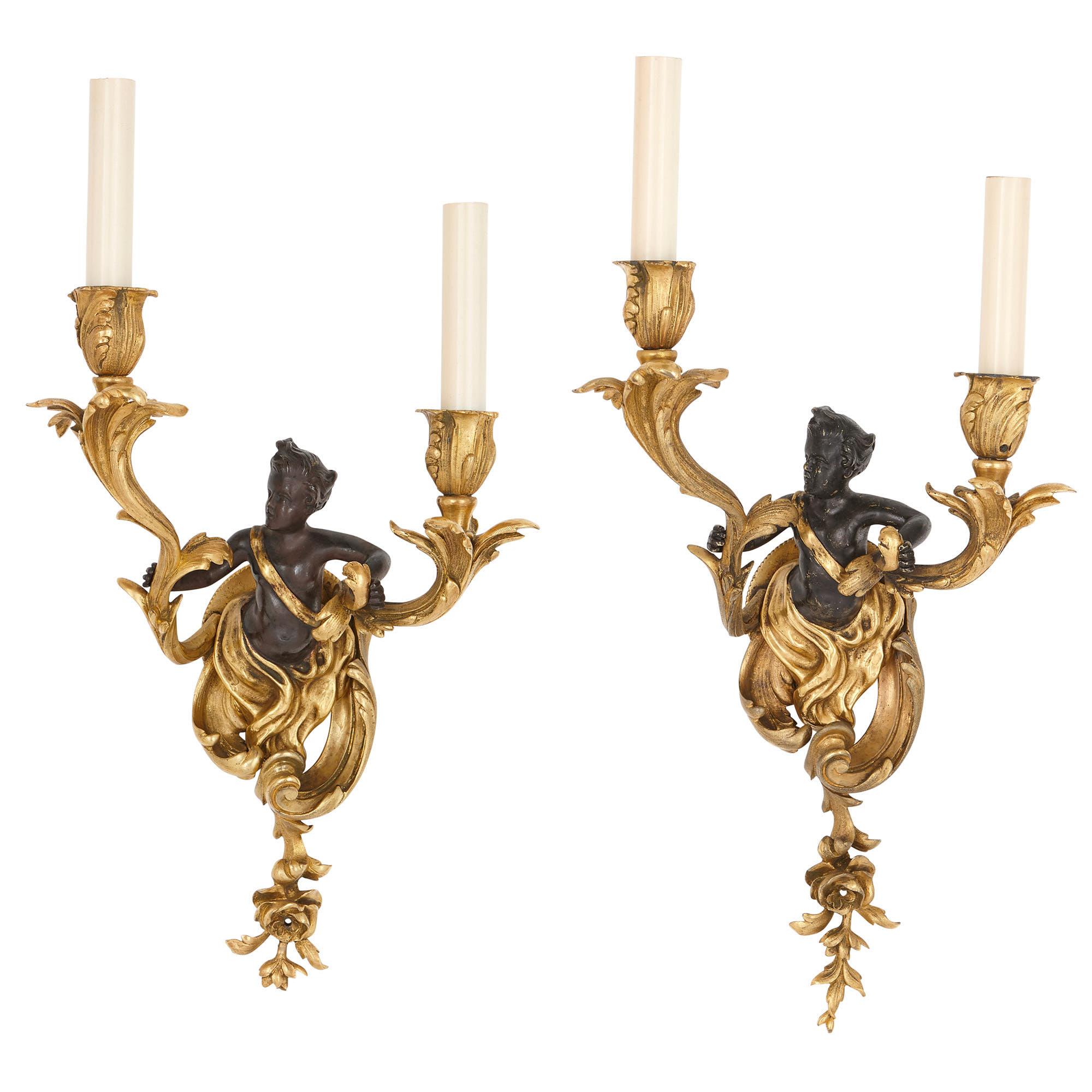 These sconces (wall lights) are wonderful examples of the 18th century Louis XV style, which was fashionably revived in the 19th century. The style was characterised by its rocaille motifs, including C- and S-scrolls, curling acanthus leaves, flower
