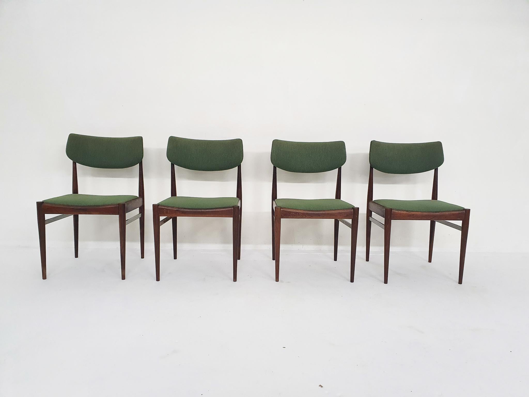 Four rosewood dining chairs with green upholstery. Some light stains on the fabric.