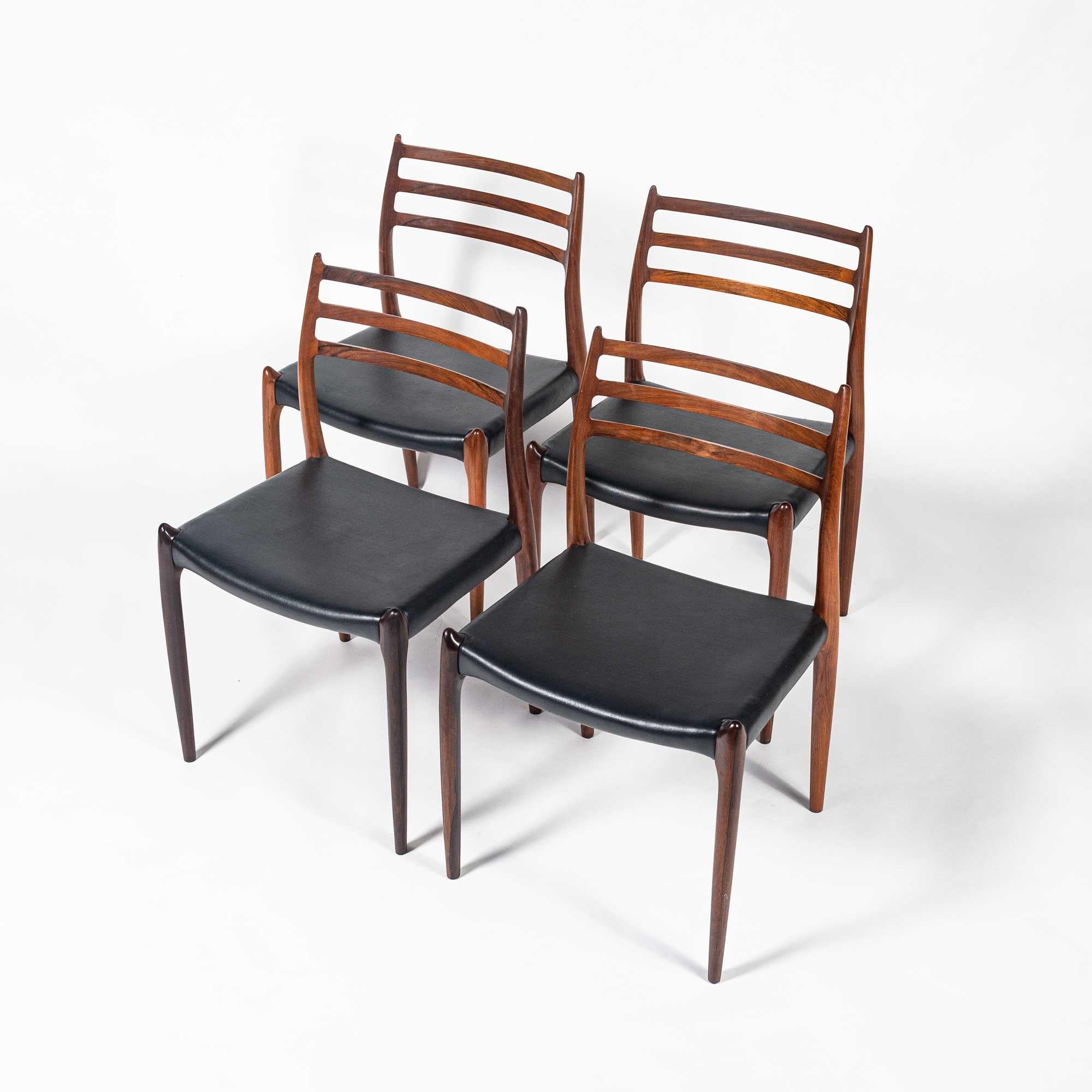 Rare and iconic set of for rosewood dining chairs model 78, designed by Niels Otto Moller for JL Møller Møbelfabrik in 1954. This set is in original condition, with original black leather seat. Label are on all chairs.

The set is in great vintage