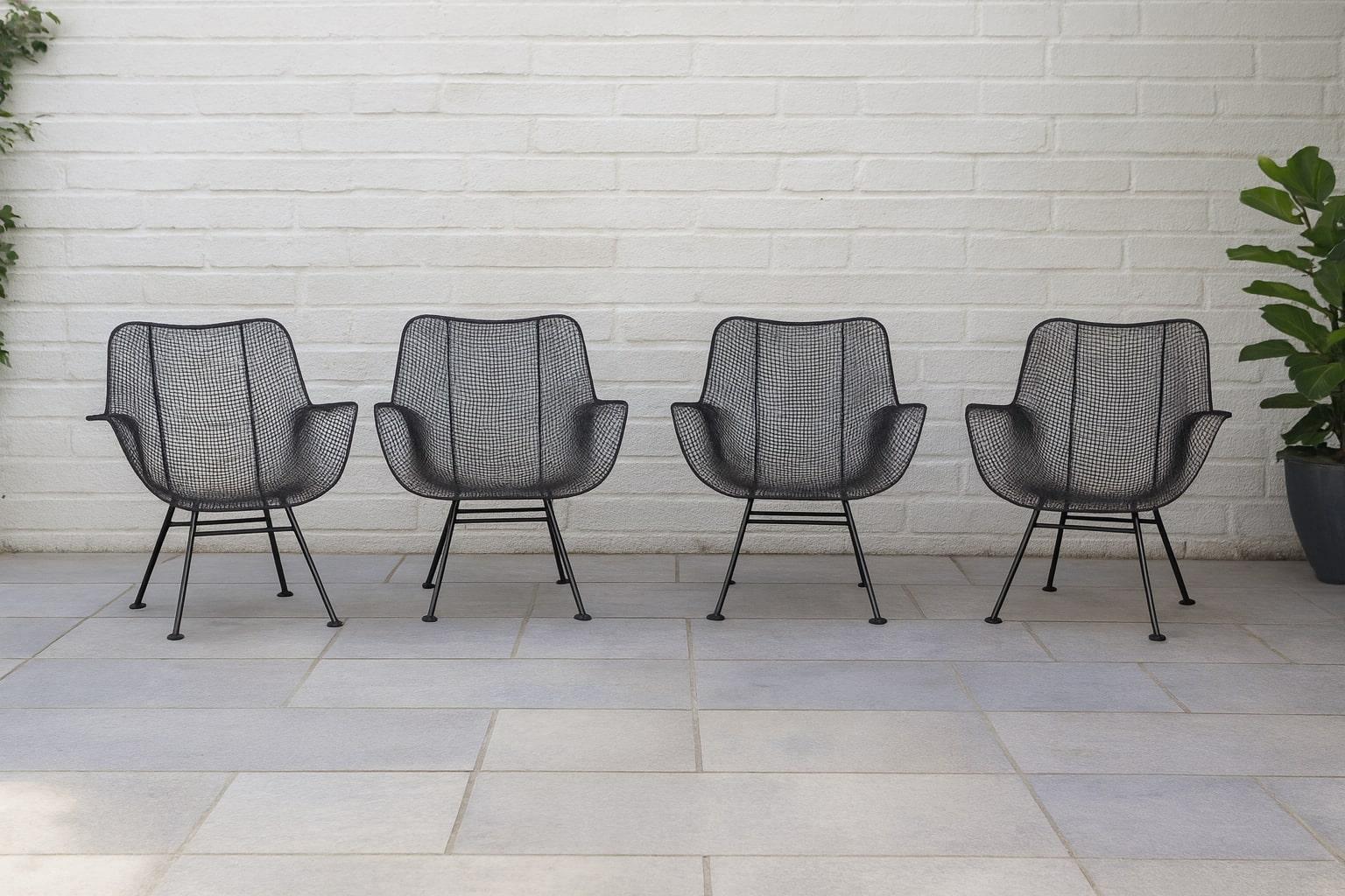 An exceptional matched set of four original Russell Woodard “Sculptura” lounge chairs, designed in 1956 and celebrated as an icon of mid-century modern outdoor design. These museum-worthy pieces are constructed of hand-formed, woven steel mesh over