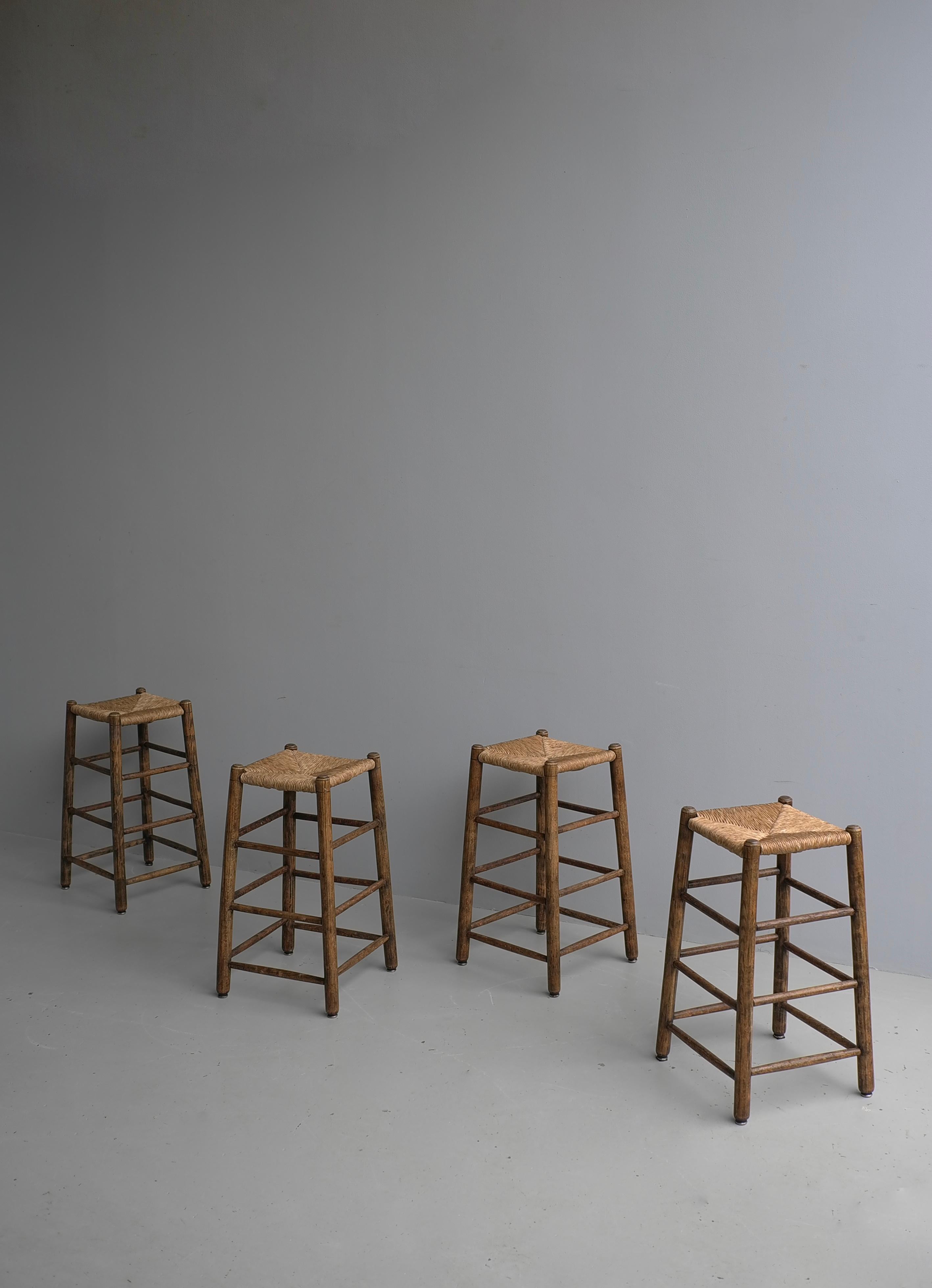 Set of Four Rustic French Mid-Century Modern Counter Bar Stools in Solid Oak with Rush seats.