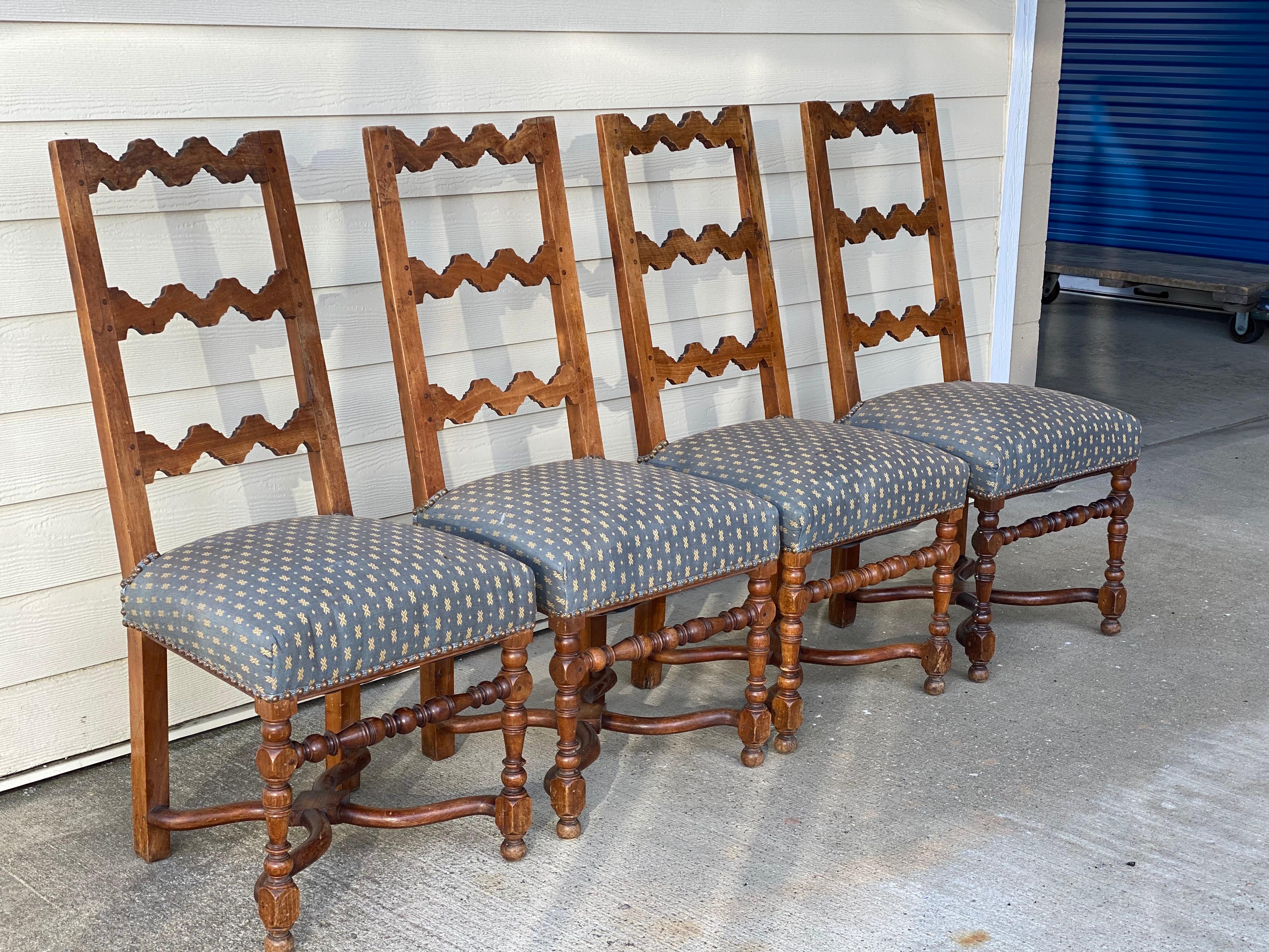 Set of four Rustic style oak ladder back side chairs, early 20th century
An unusual set of chairs with the zig zag backs, turned legs and beautiful curved x stretchers. A fresh fun fabric would update these chairs significantly. Some loss underside