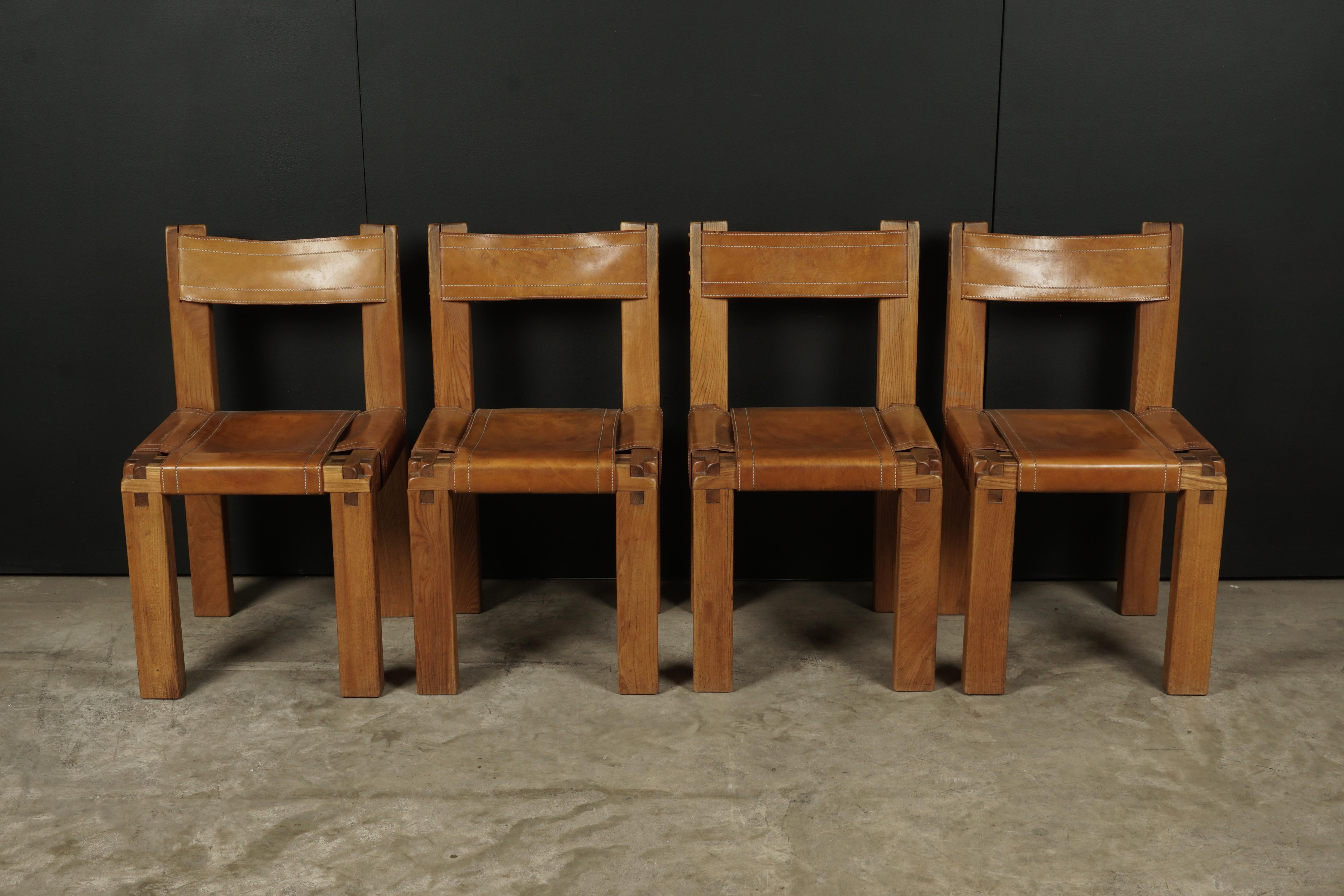 Set of four S11 chairs by Pierre Chapo, France, circa 1960. Solid elmwood construction with original cognac leather. Very good quality and condition.