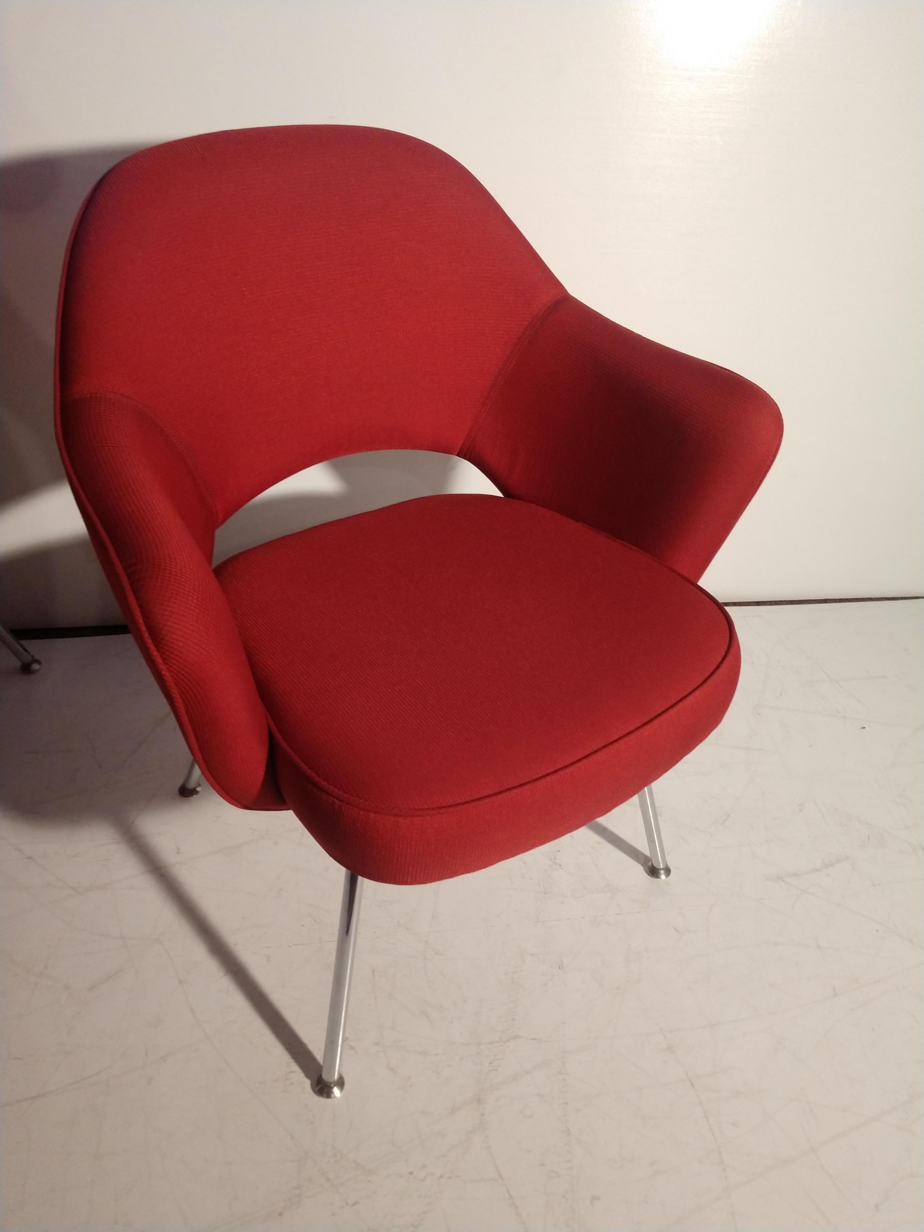 Set of 4 Saarinen executive chairs in a red fabric. Chairs are basically new, have not been used very much at all. Tag reads distributed by knoll. Measure: Seat height is 17.