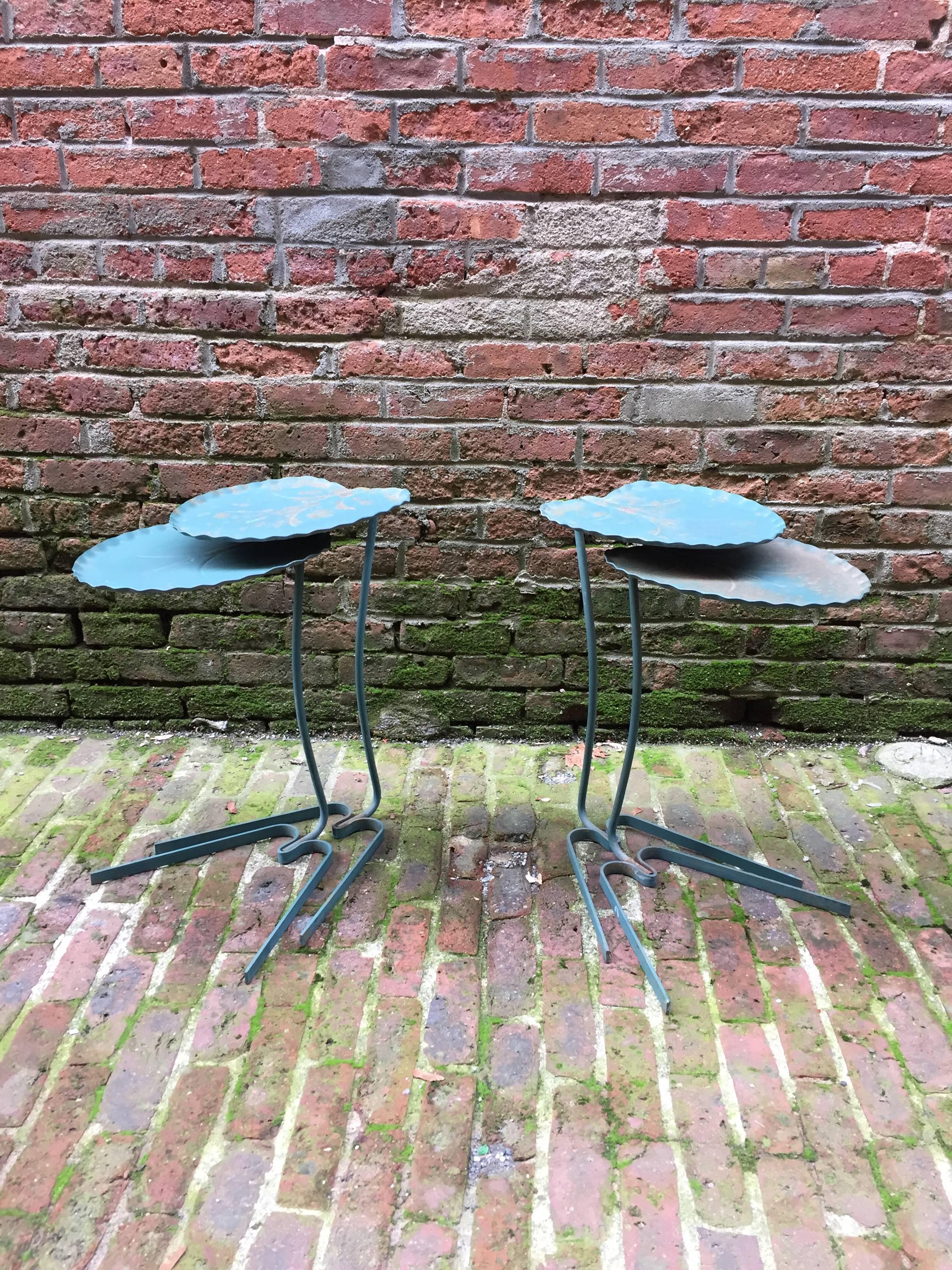 Two pairs of Salterini outdoor iron flora form tables, circa 1950-1960. These have clear Art Nouveau inspiration with a very modern flair. Original green paint. Structurally sound and in good, original condition. They nest together or can separate