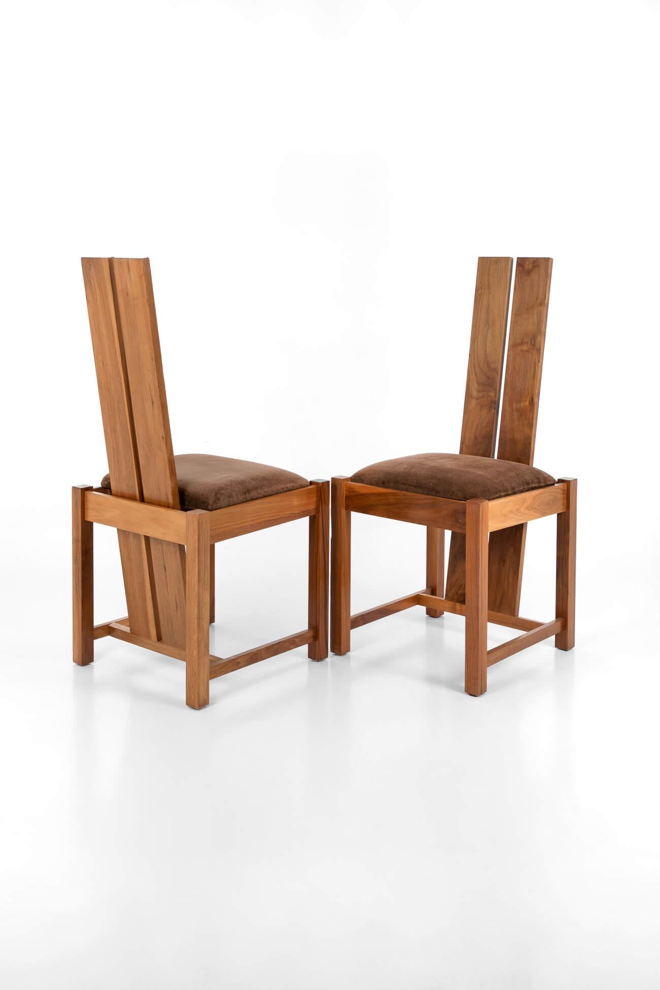 Set of four Samuel Chan Alba high back dining chairs, designed for Channels of Chelsea. In solid walnut with the original upholstery, in very good condition with light wear consistent with age. Stamped with the Channels of Chelsea makers mark. Price