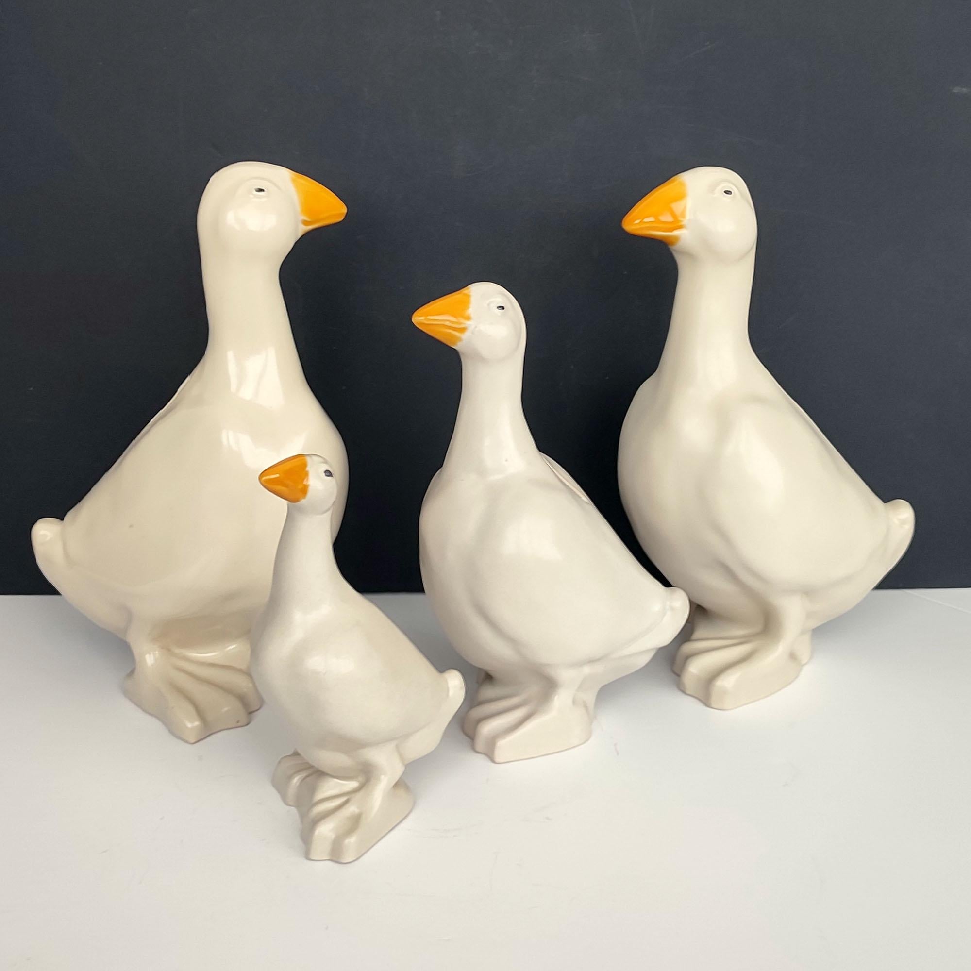 Set of Four Scandinavian ceramic goose money banks, Höganäs Keramik Sweden 1990s. Each marked under the bottom with maker's marks, and some dated. One key available for all. Satin glaze on bodies with glossy orange glaze on beaks. Very good over all