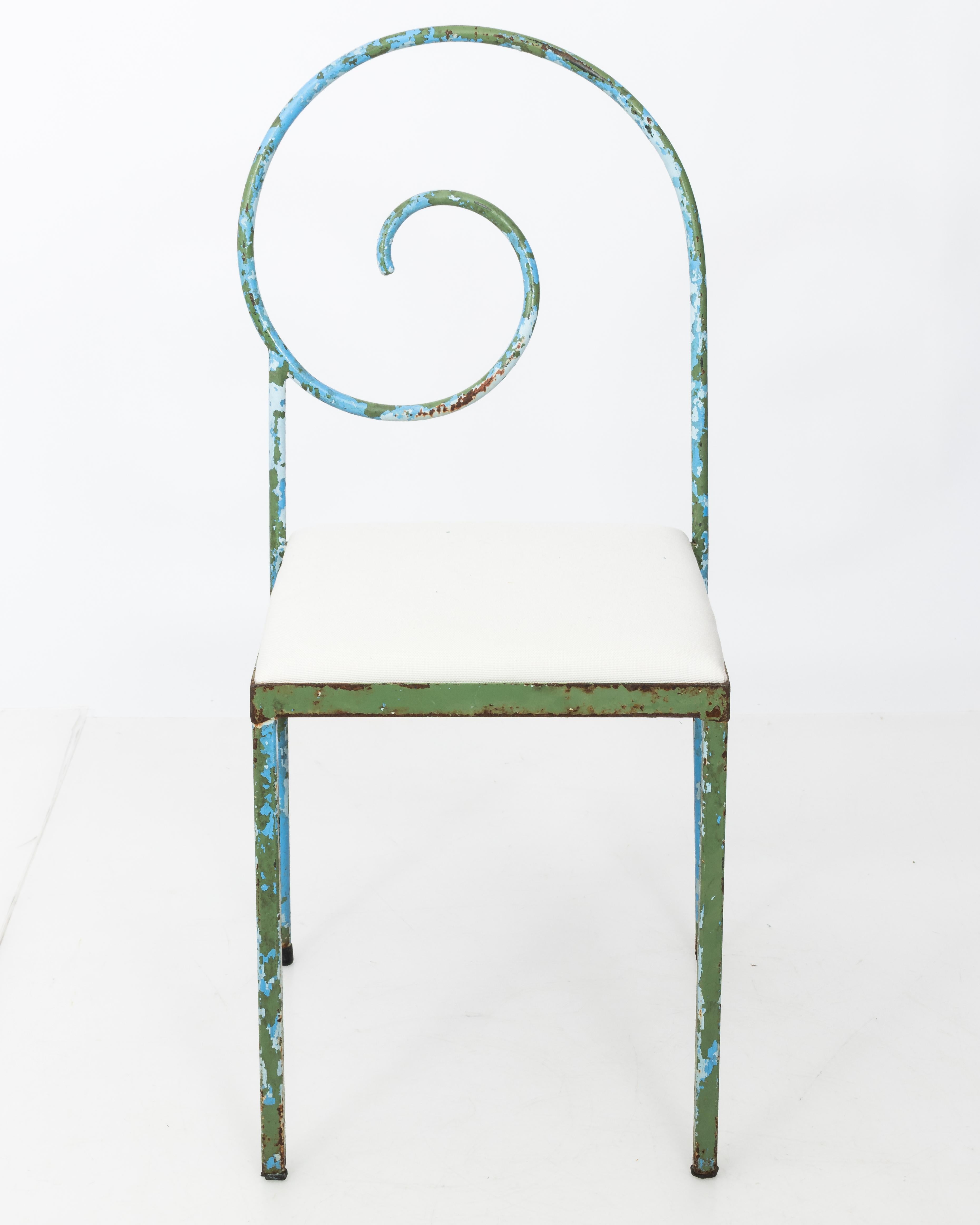 Scarce set of sculptural chairs in the style of the Suspiral chair by Luigi Serafini. Discovered in a market in France, these mid century chairs are one of a kind. Minimal silhouette with a classical scroll design at backrest. The iron frames have a