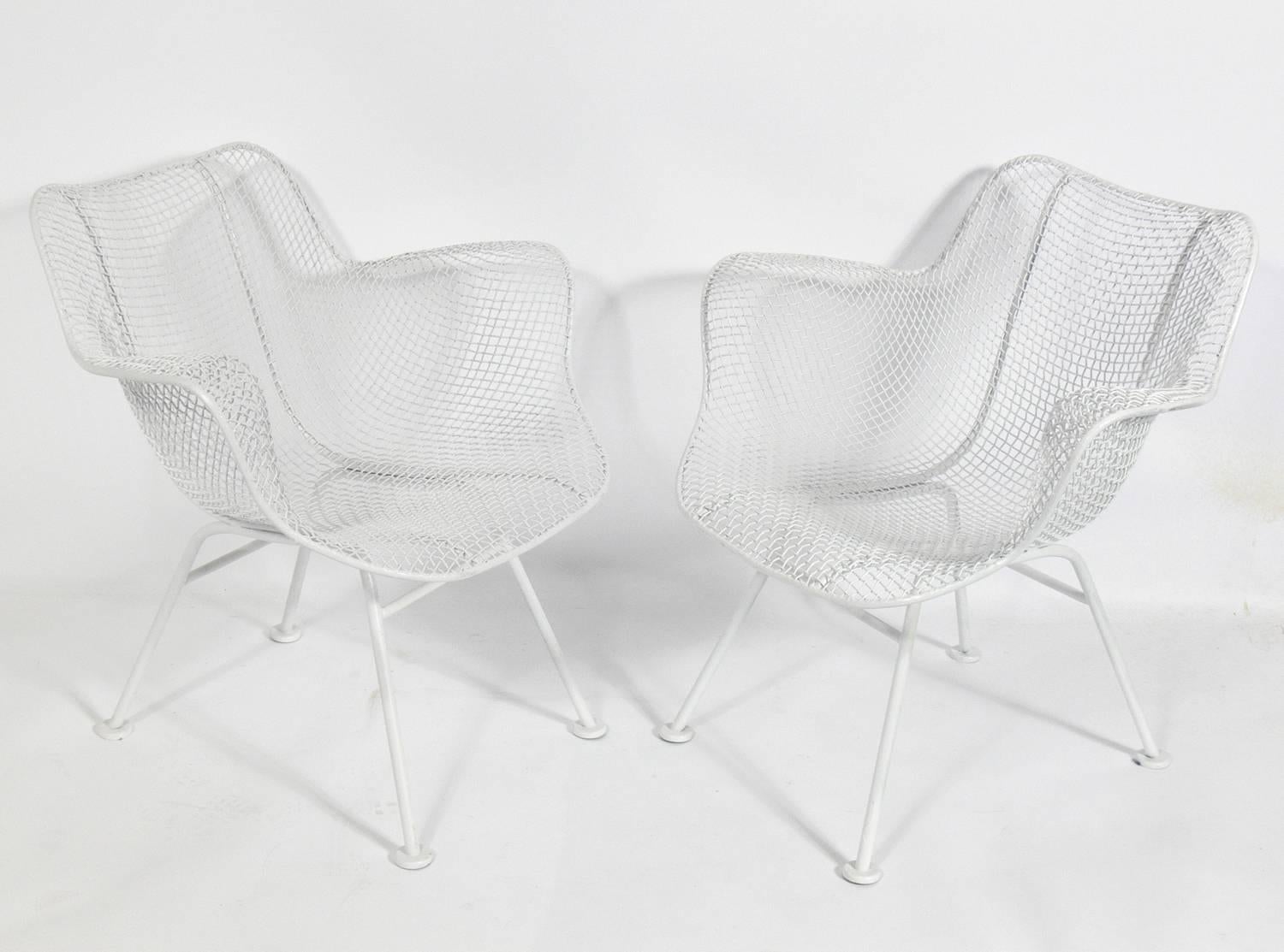 Set of four Sculptura chairs, designed for the Woodard Furniture Company, American, circa 1960s. They are a versatile size and can be used as dining or lounge chairs. They have been repainted in white.
