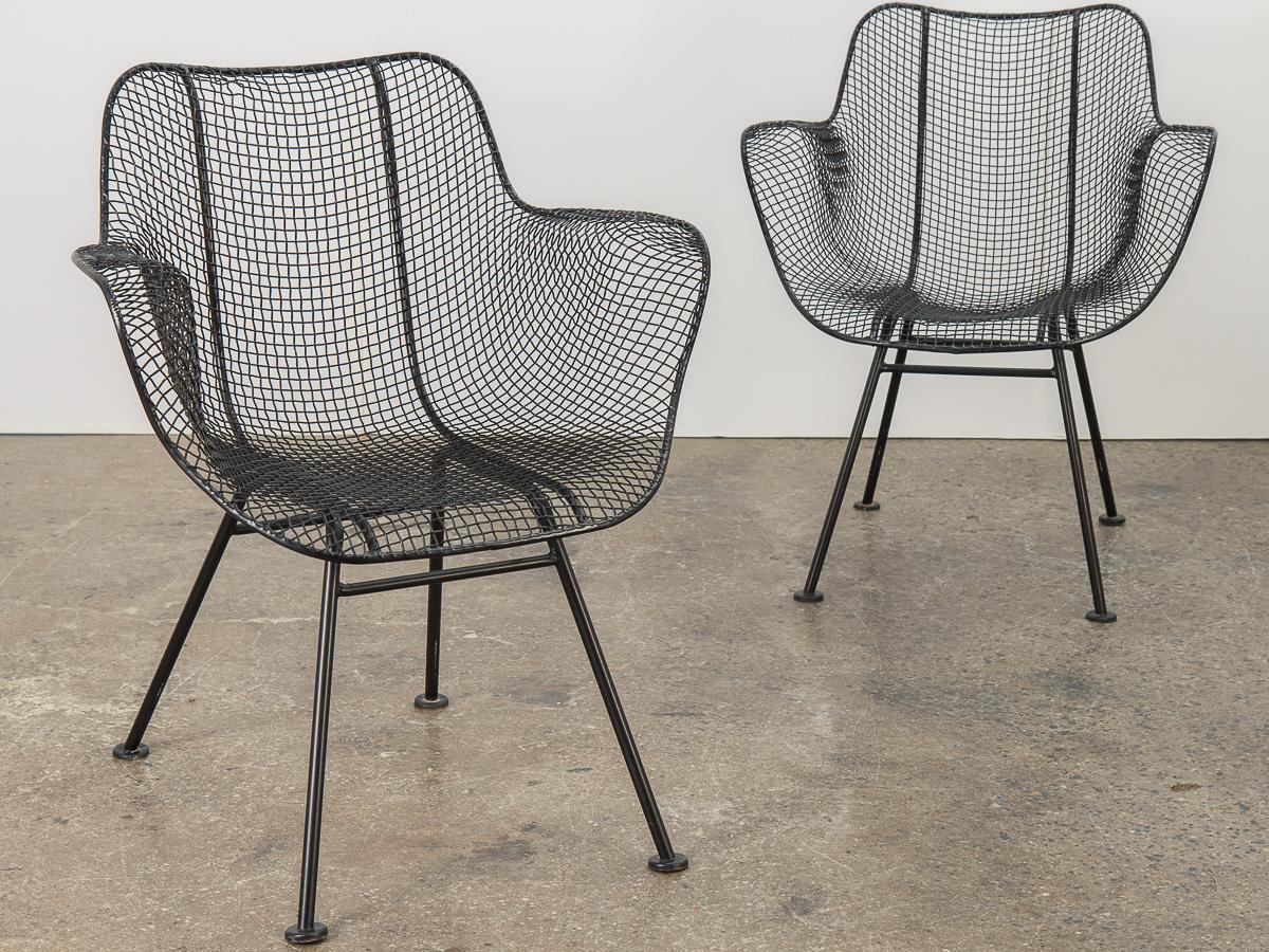 Set of four original sculptura armchairs, designed by Russell Woodard. An airy design achieved by mesh steel on a wrought iron frame. Black satin finish has been recently professionally powder coated. A versatile option for outdoor entertaining,