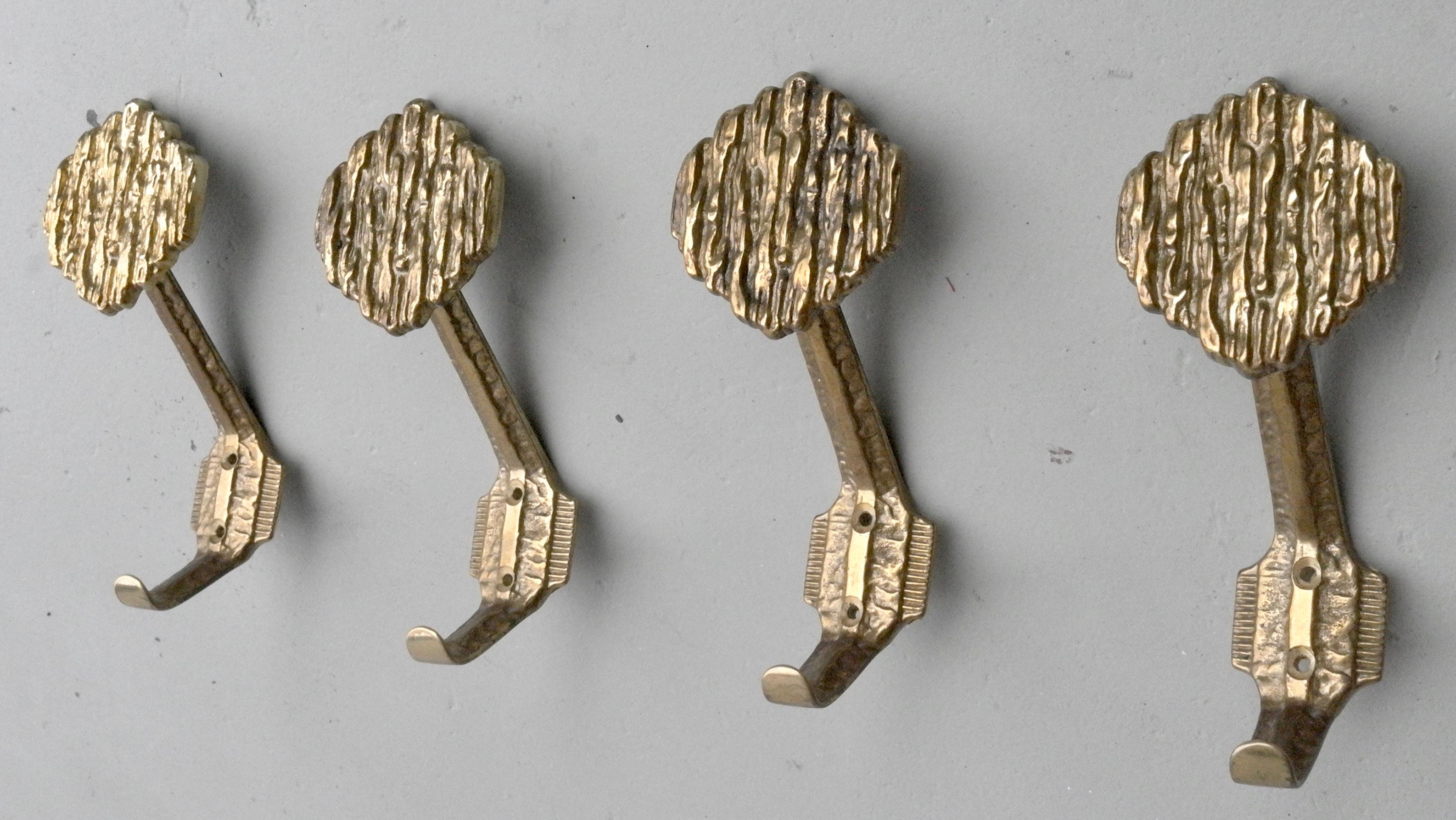 Set of four brass art coat hangers, 1960s, included all screws in brass.