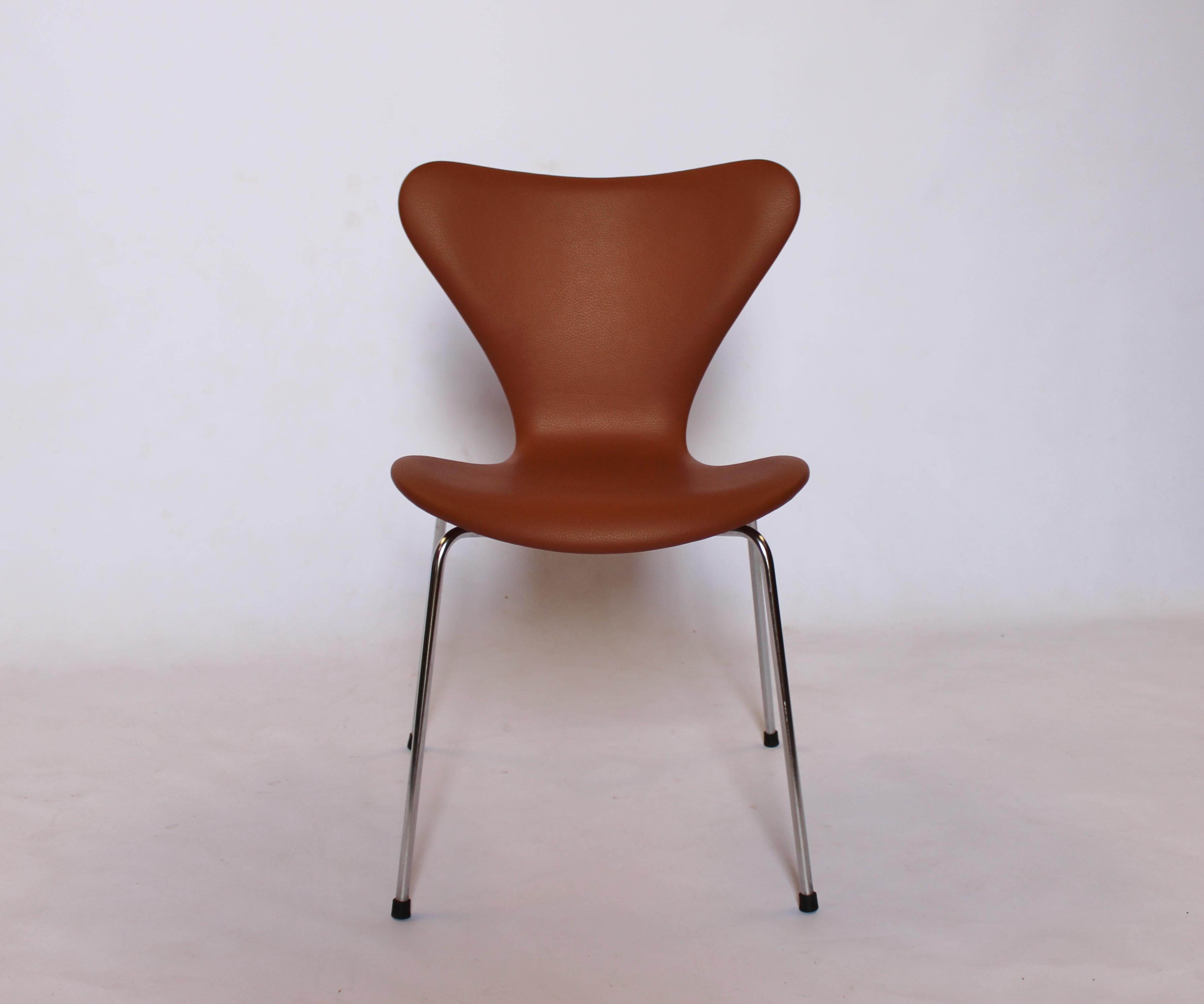 A set of four Seven chairs, model 3107, designed by Arne Jacobsen and manufactured by Fritz Hansen in 1967. The chairs are newly upholstered in cognac classic leather and are in excellent vintage condition.