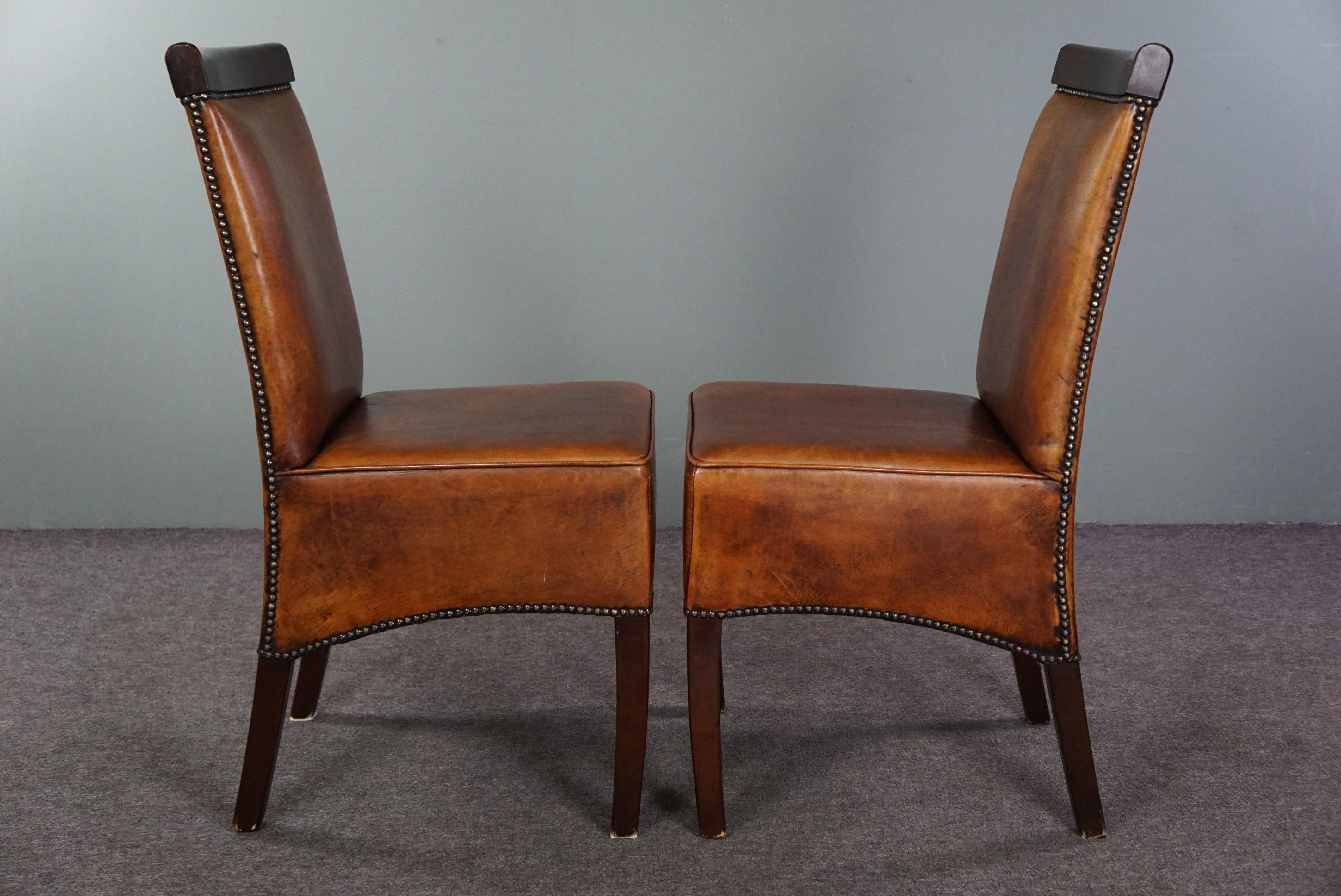 Offered is this set of four sheep leather Art Deco dining chairs. This beautiful set of four sheep leather dining chairs in Art Deco style offers more than just comfortable seating. Art Deco reflects an era of elegance and sophistication. These