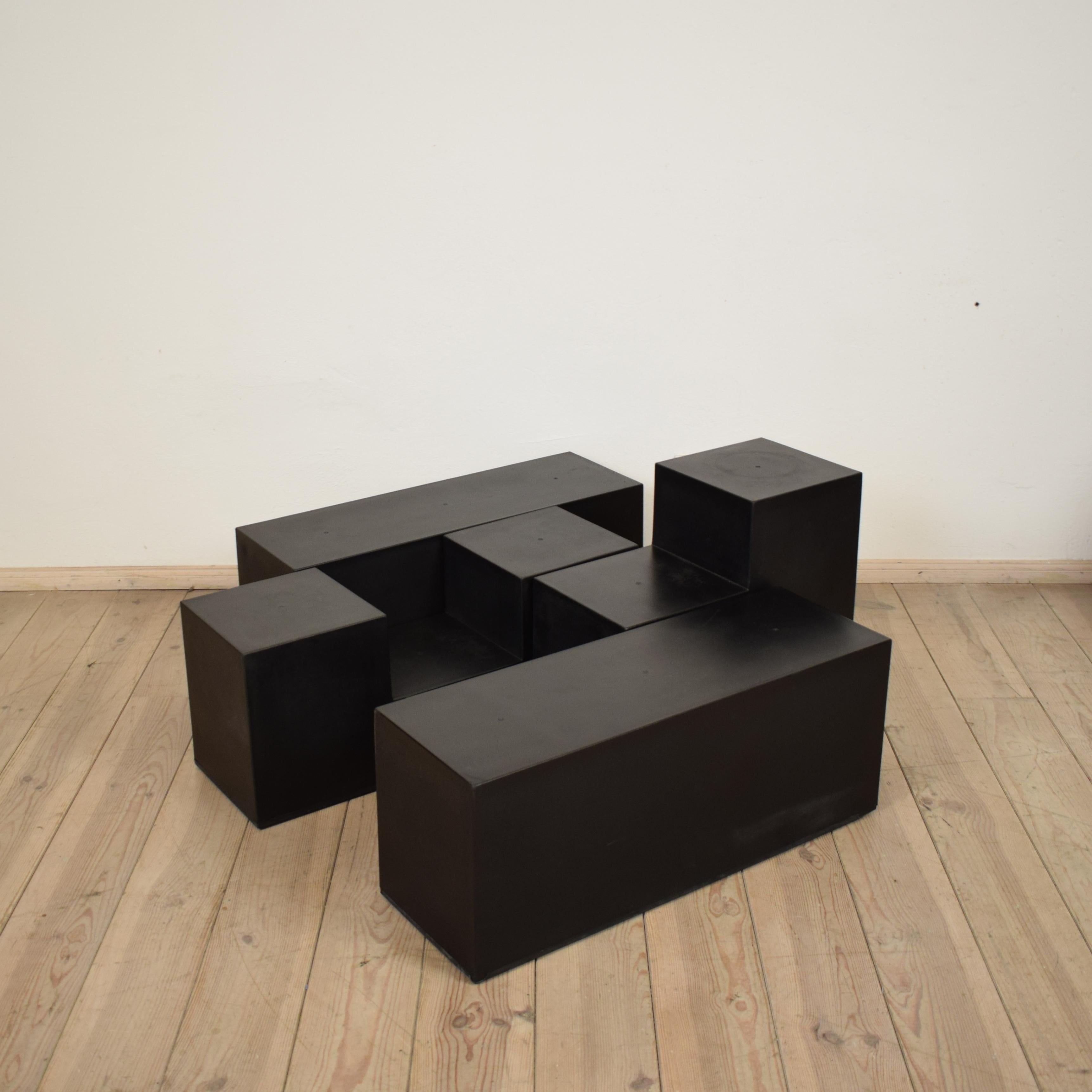 This great set of four modular elements ‘Gli Scacchi,’ designed by Mario Bellini for B&B Italia in 1971, can be combined in various ways to be used as side tables or seating units.
The elements are made of black duraplum plastic.
They resemble
