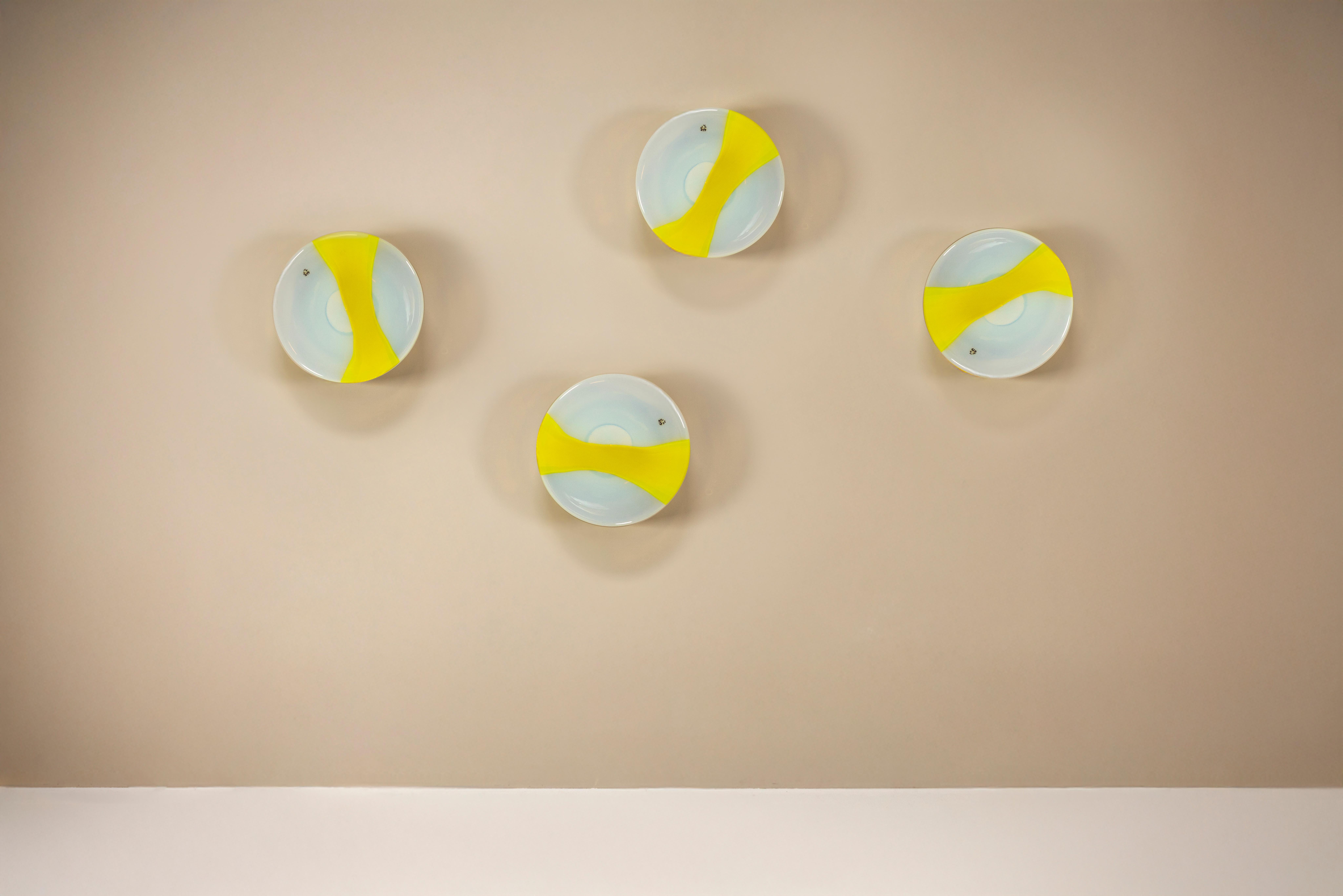 Some designs carry movement without ever shifting. These “Sierra” wall lights by Roberto Pamio for Leucos, produced in the 1980s, appear as if frozen mid-gesture—light caught inside a soft turn of color and form.

Design
Each piece is made from
