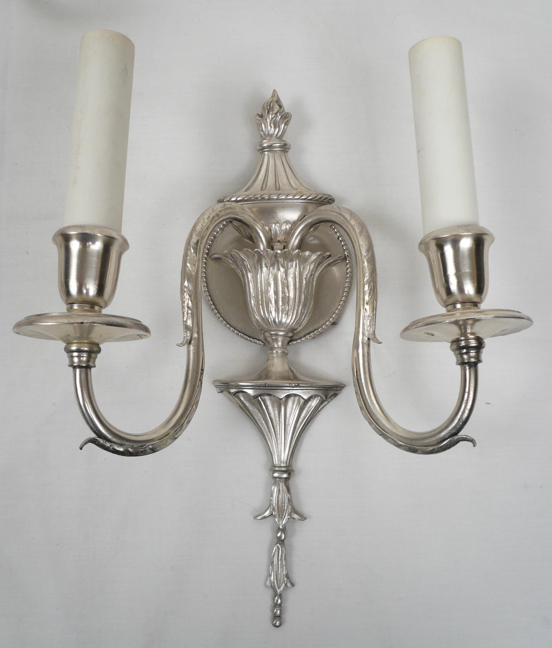 This set of four signed Caldwell silver sconces feature classic Georgian details made popular by Robert Adam, that include acanthus leaves and bellflowers.