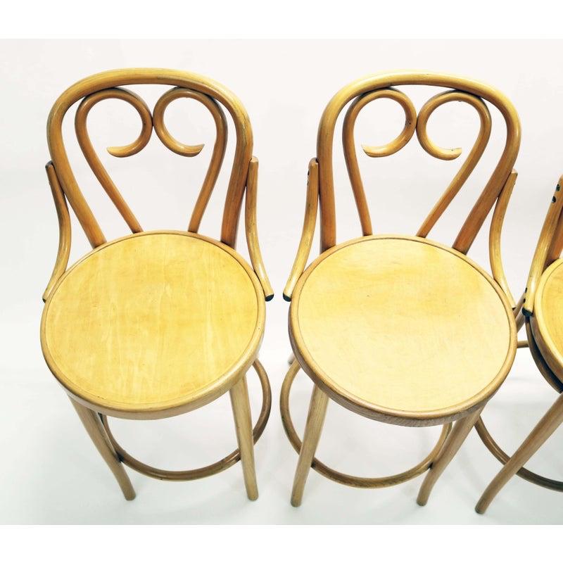 A rare, beautiful set of four midcentury Thonet counter-height bar stools in beech bentwood. 

Signed under the seat on all four stools.